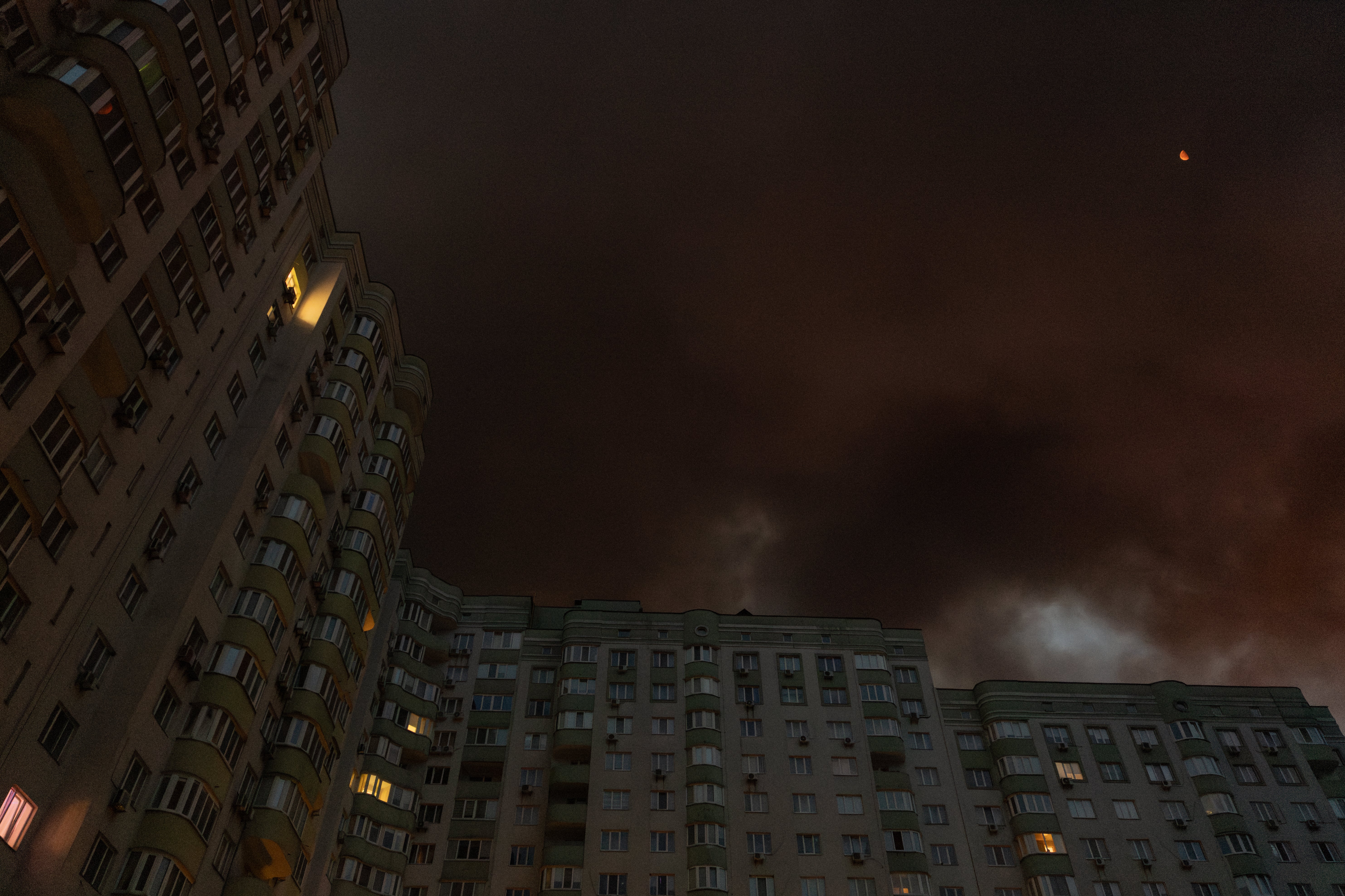 Smoke rising from a warehouse destroyed during massive Russian ballistic missile and drone strikes next to a residential building on the outskirts of Kyiv (AFP/Getty)
