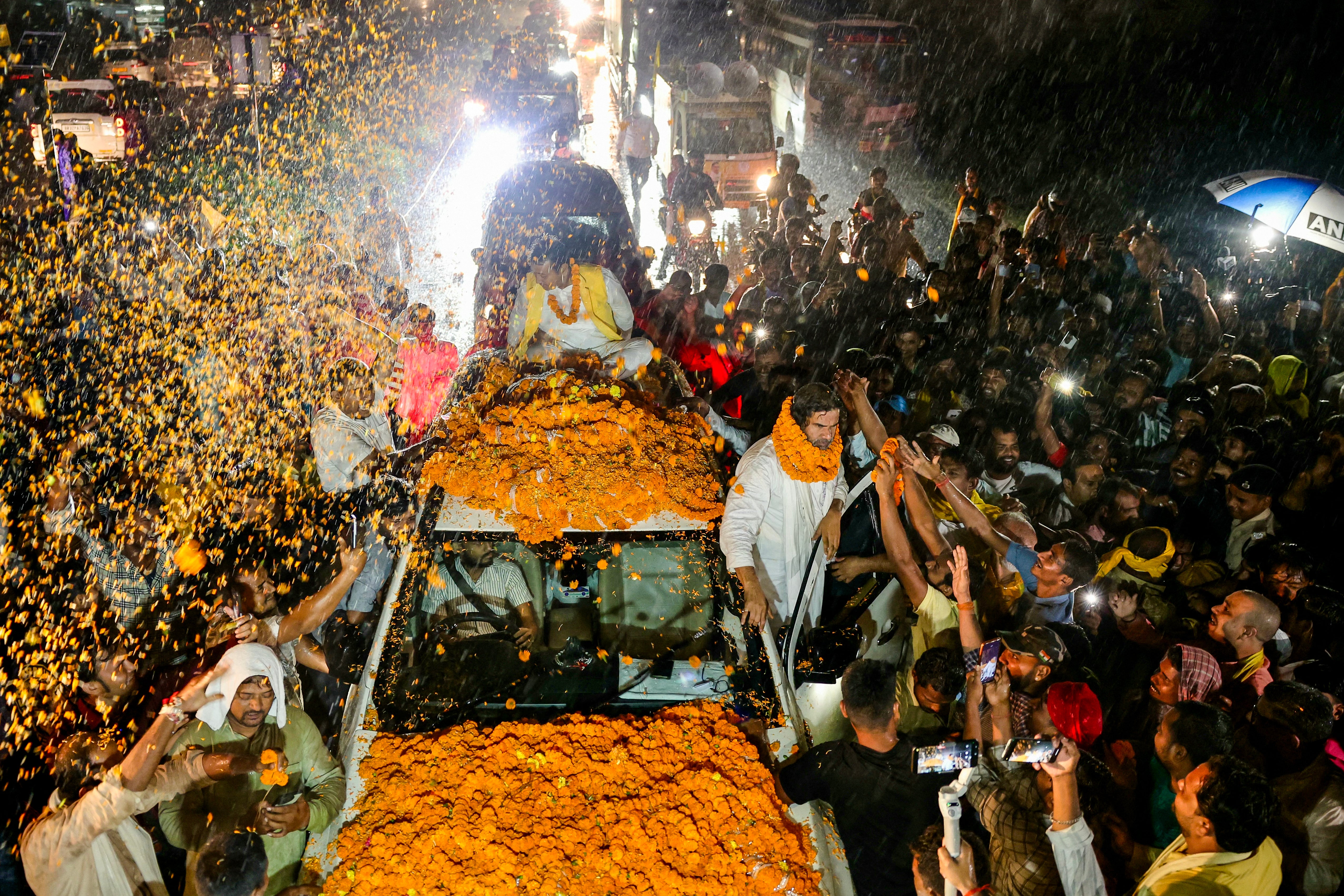 Supporters of Prashant Kishor welcome him with marigold garlands during a rally in Darbhanga, Bihar