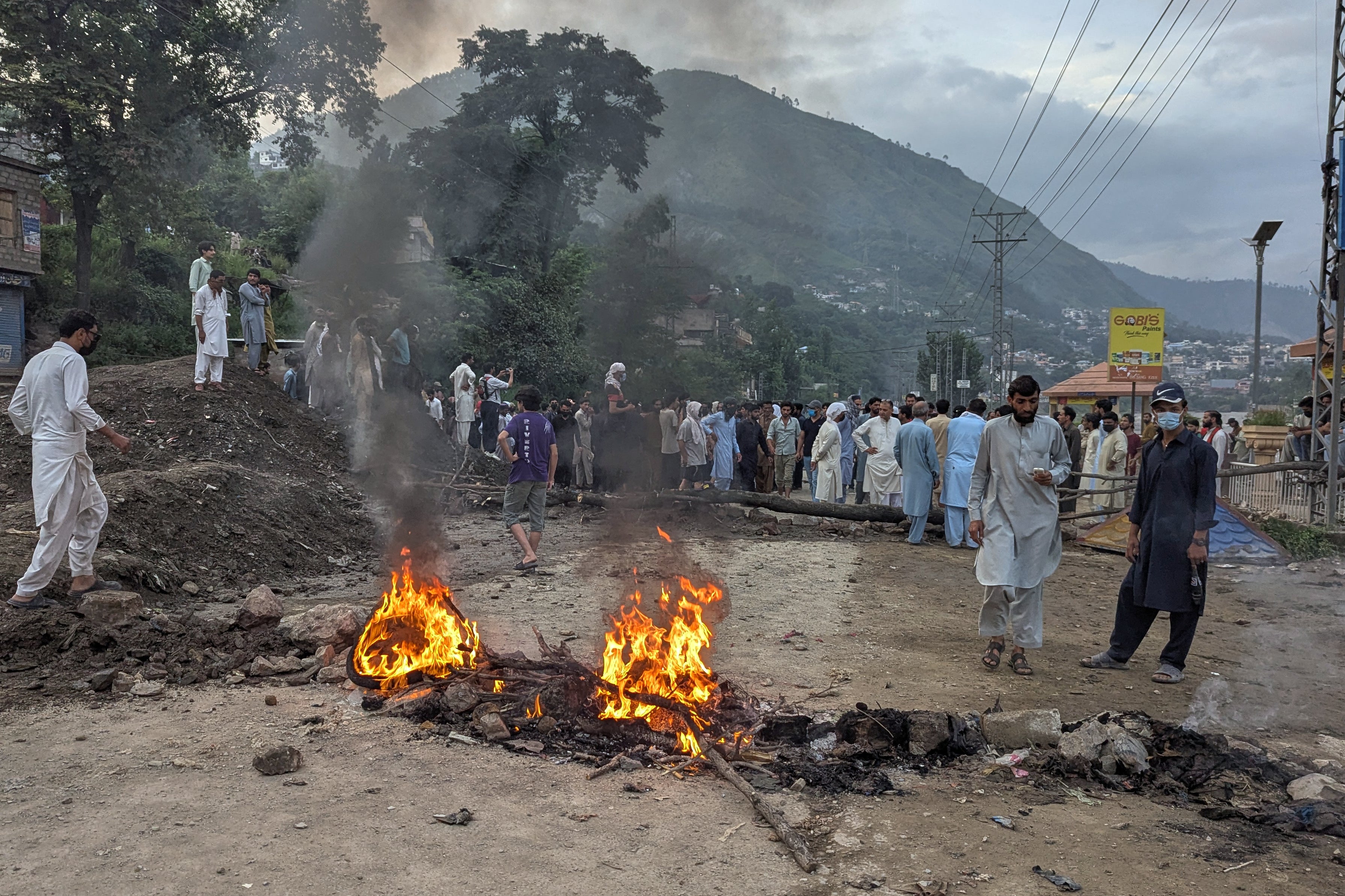 Supporters of the Joint Awami Action Committee block a road after clashes with police in Muzaffarabad (AP)