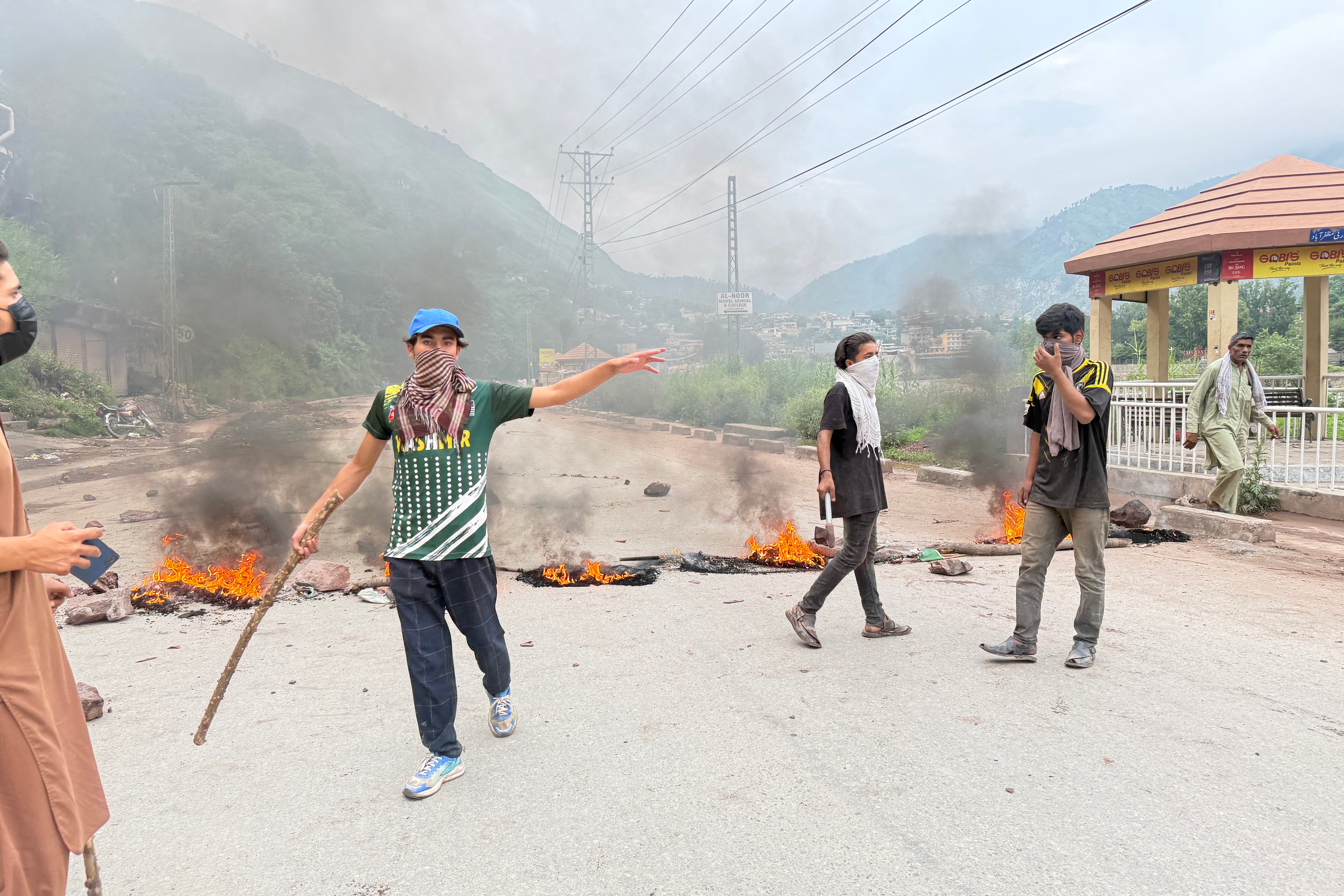 Protestors burn tyres along a road after clashes with police in Muzaffarabad on 31 July 2026 amid unrest during the first phase of voting for the local legislature in Pakistan-administered Kashmir (AFP/Getty)