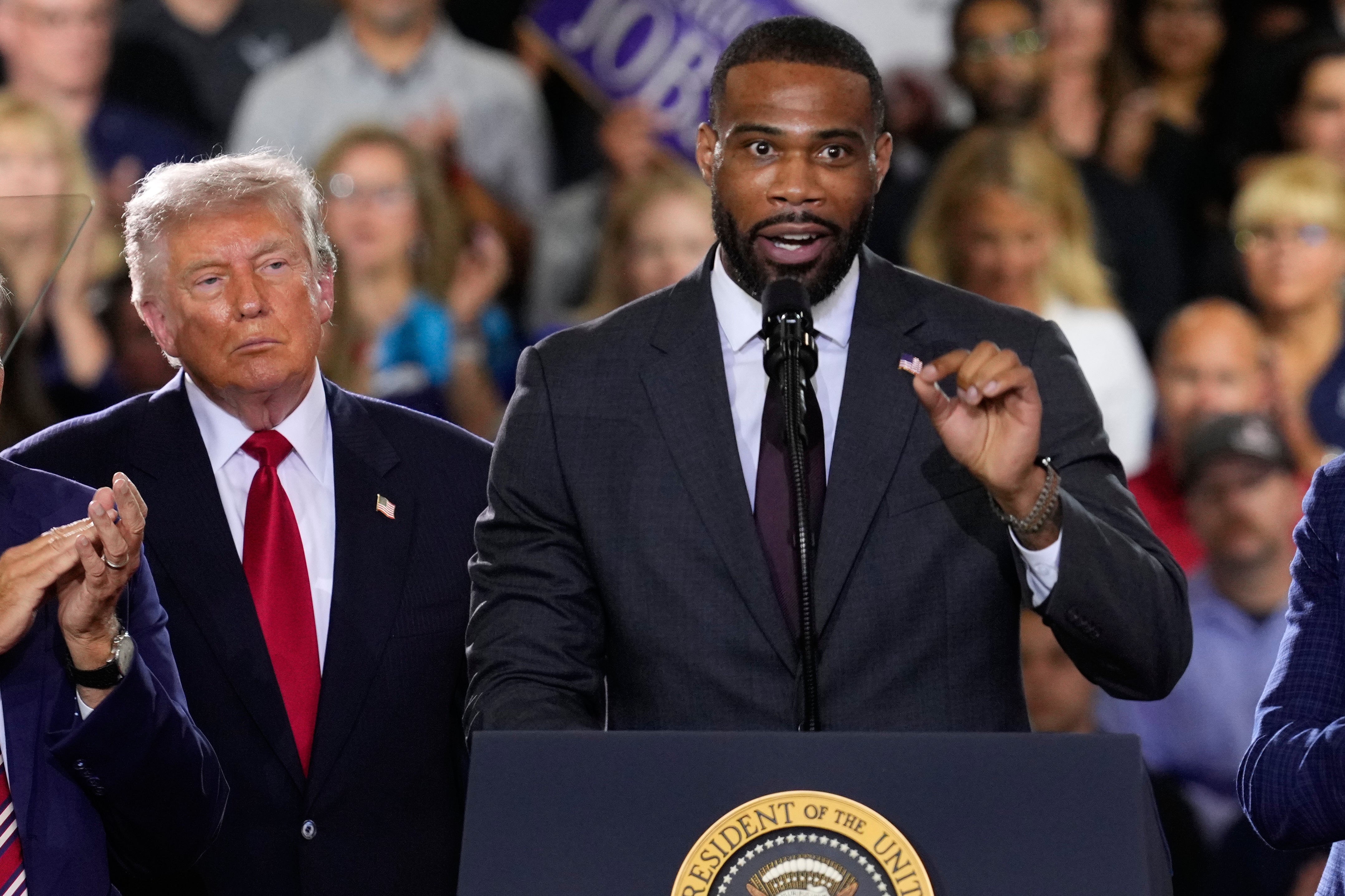 Amir Hassan (pictured center) was significantly trailing behind his GOP opponent in Michigan’s 8th congressional district race as of Wednesday morning