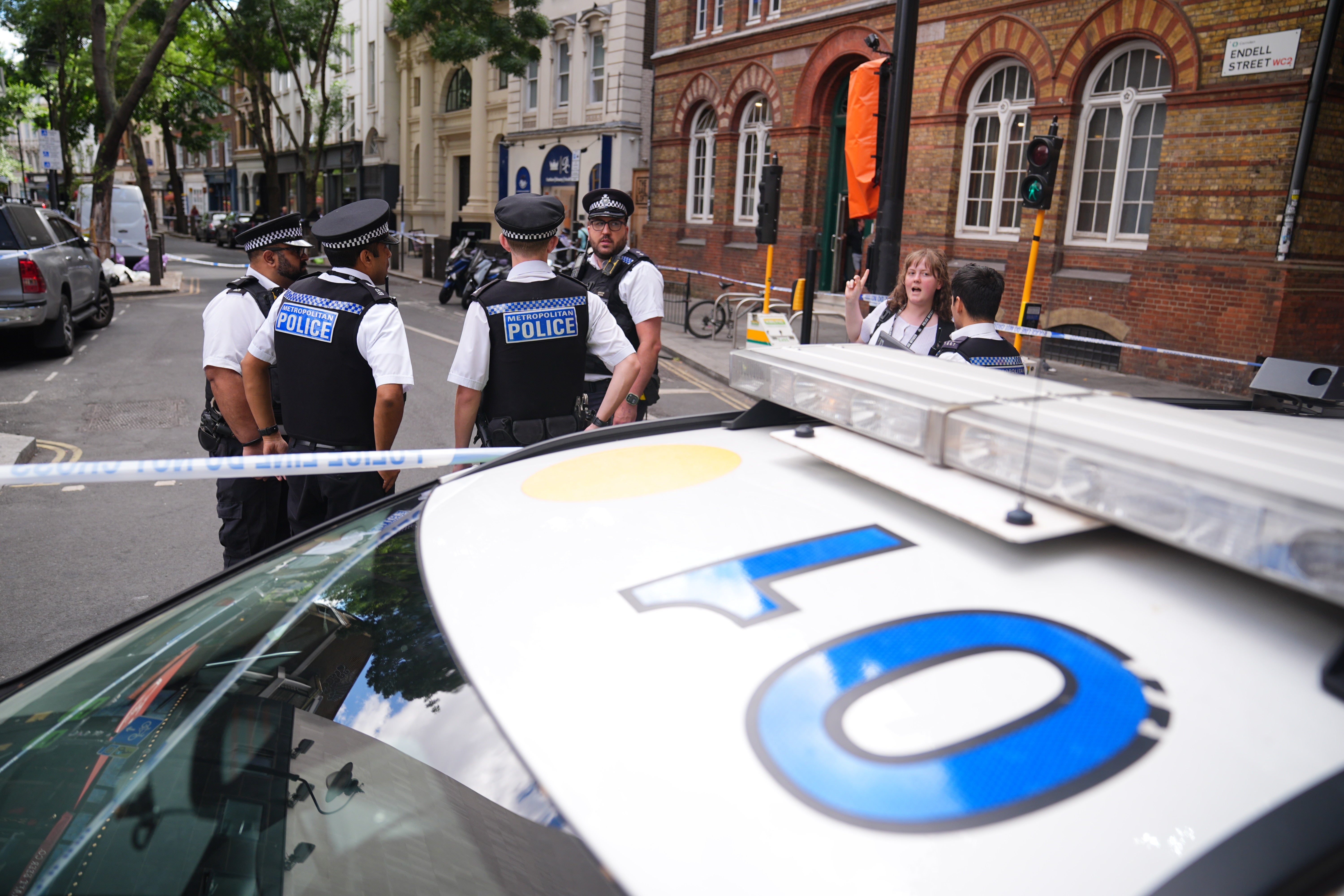 Emergency services near the scene on Endell Street in Covent Garden after four people were stabbed