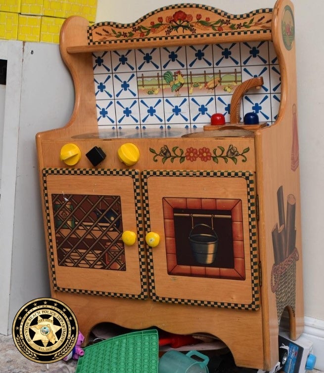 The three-year-old girl got her head stuck in the wooden kitchen while trying to retrieve a toy (Boynton Beach Police Department)