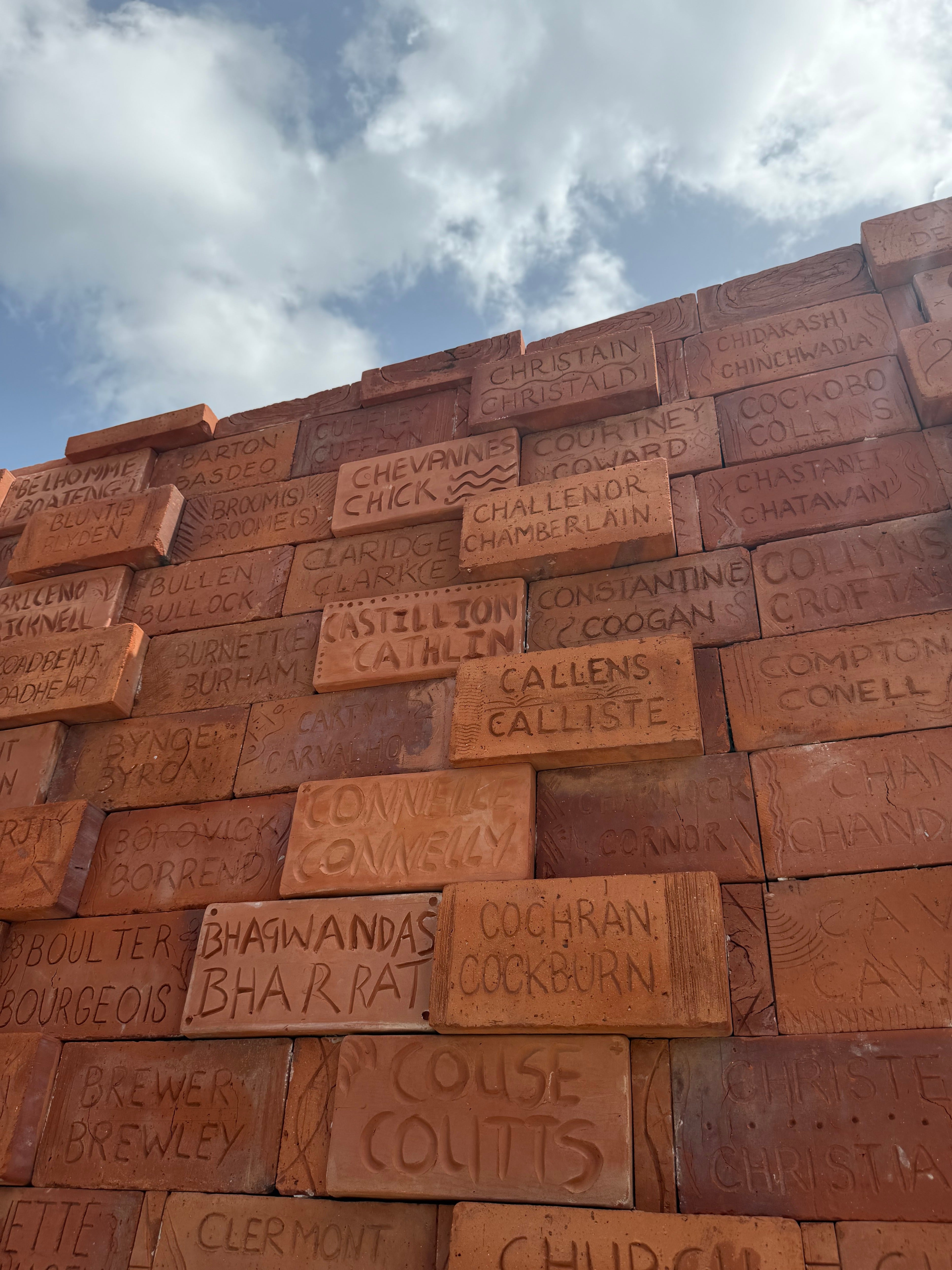 The Clarkes find their name at the Builders of Barbados Wall