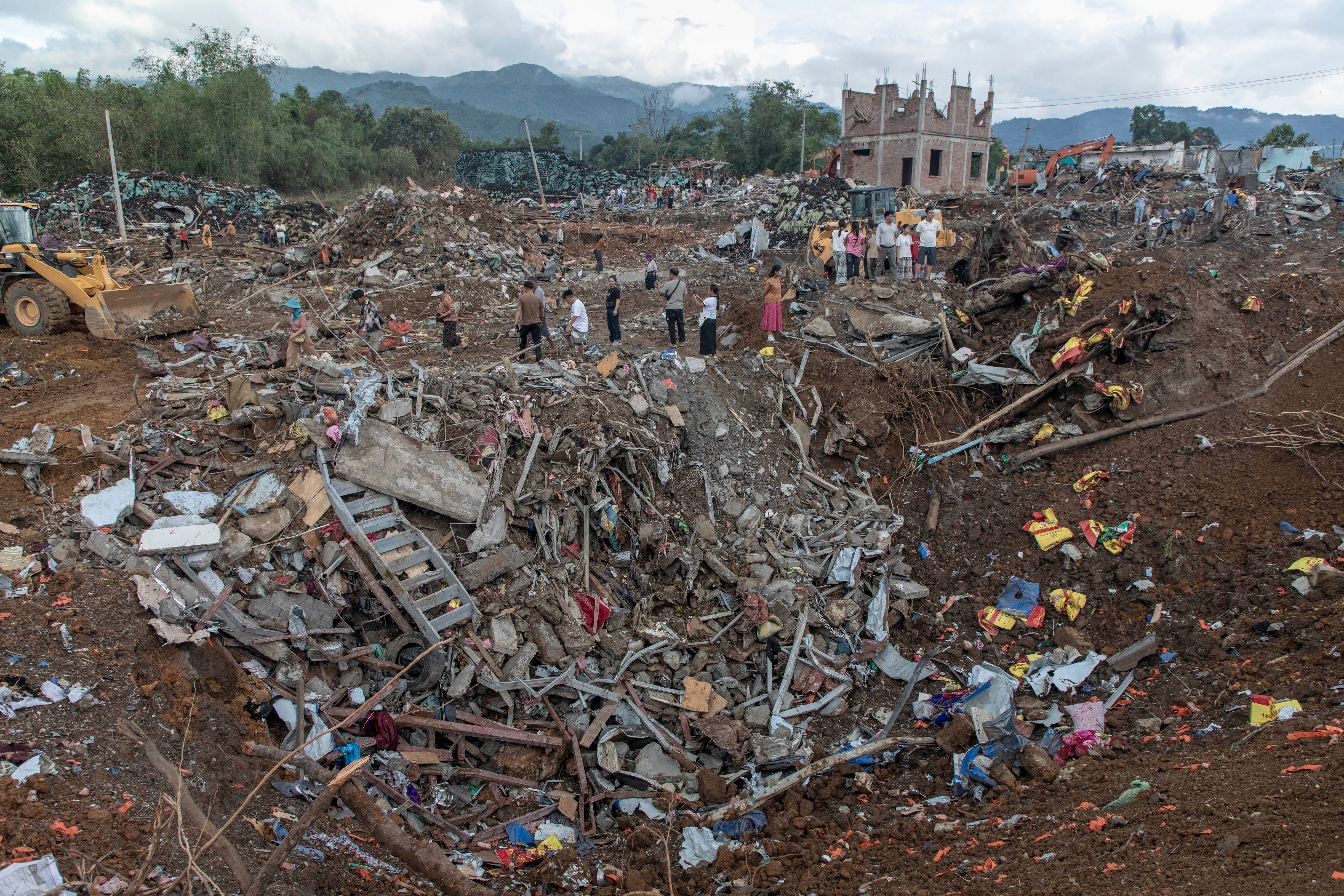 Rescuers and residents search the rubble following an explosion in Kaung Tat village in Shan state, Myanmar, on 1 June 2026 (AFP/Getty)