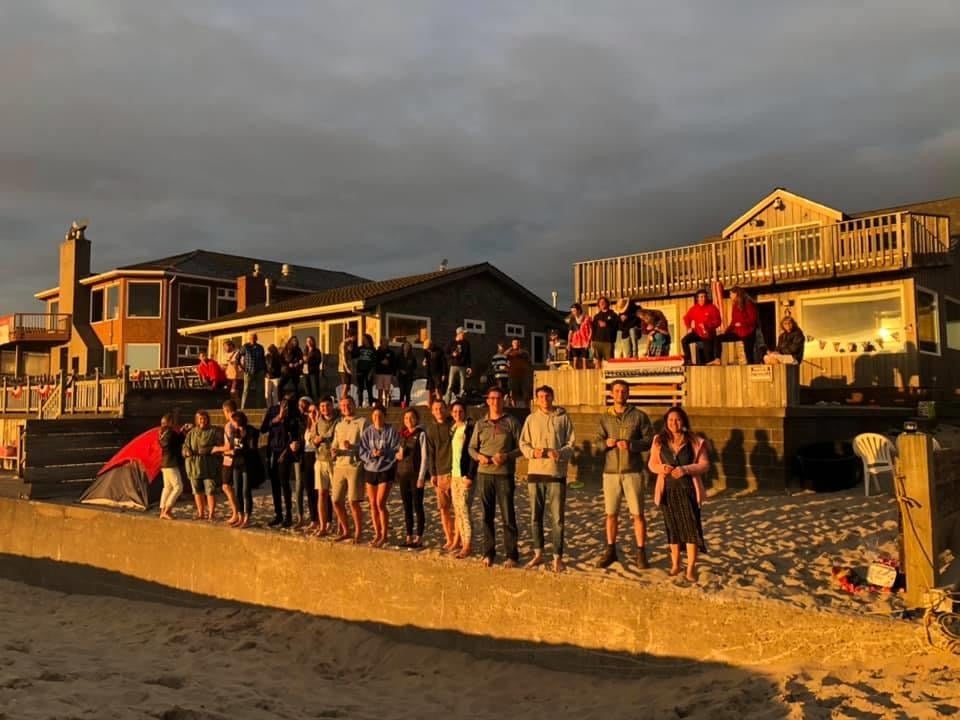 More than a dozen people stand on the seawall during an engagement party in 2020