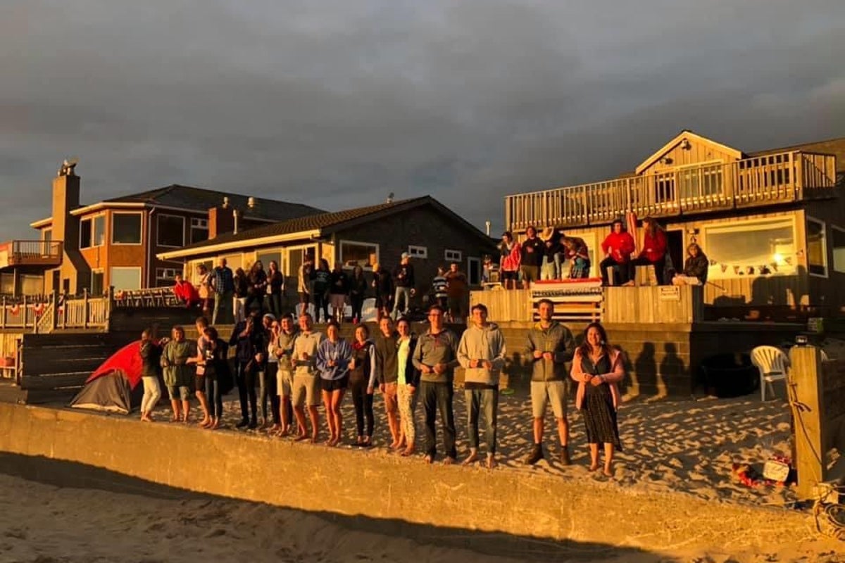 people-standing-on-seawall.jpeg?trim=39,