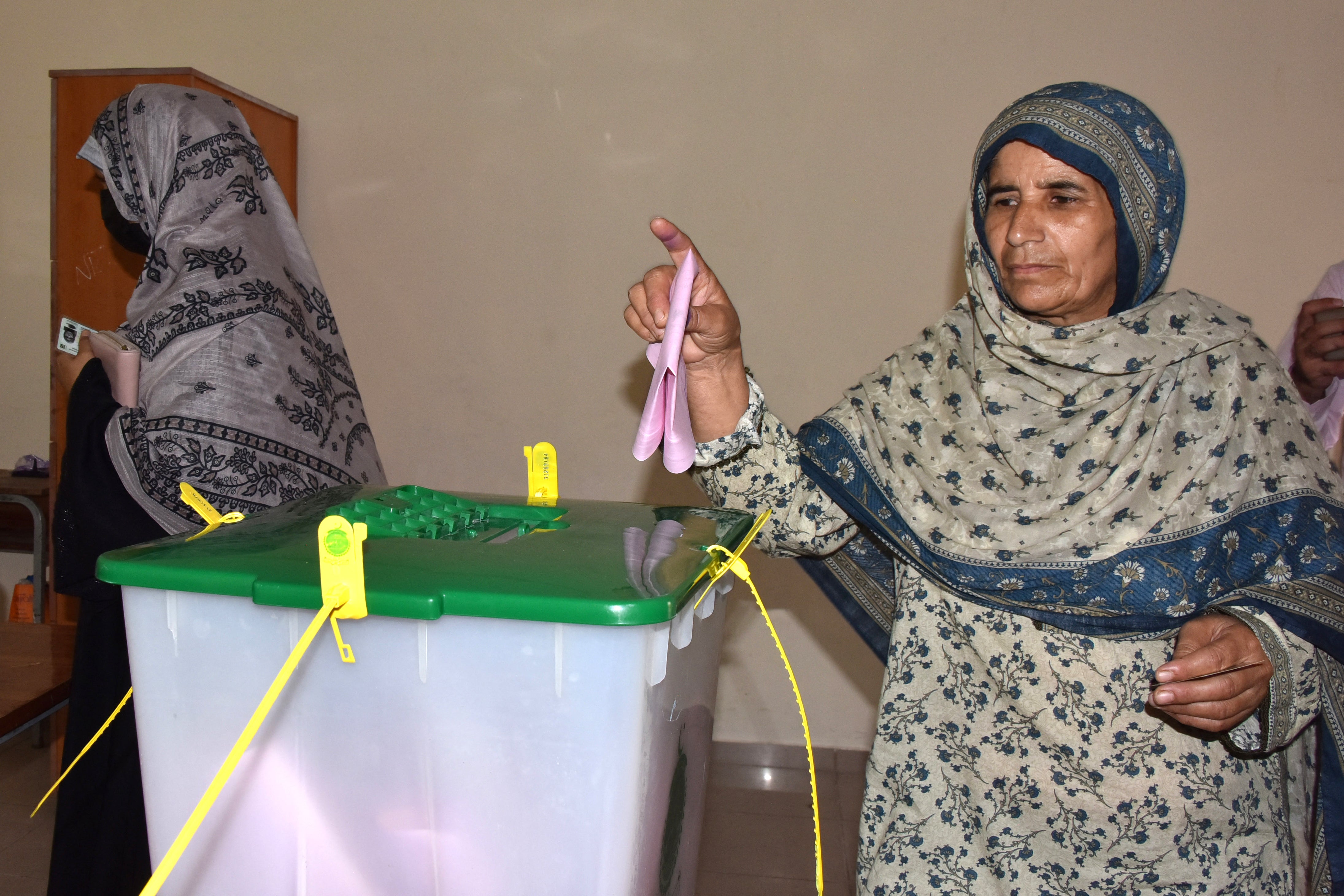 A woman casts her ballot during the second phase of regional elections in Muzaffarabad