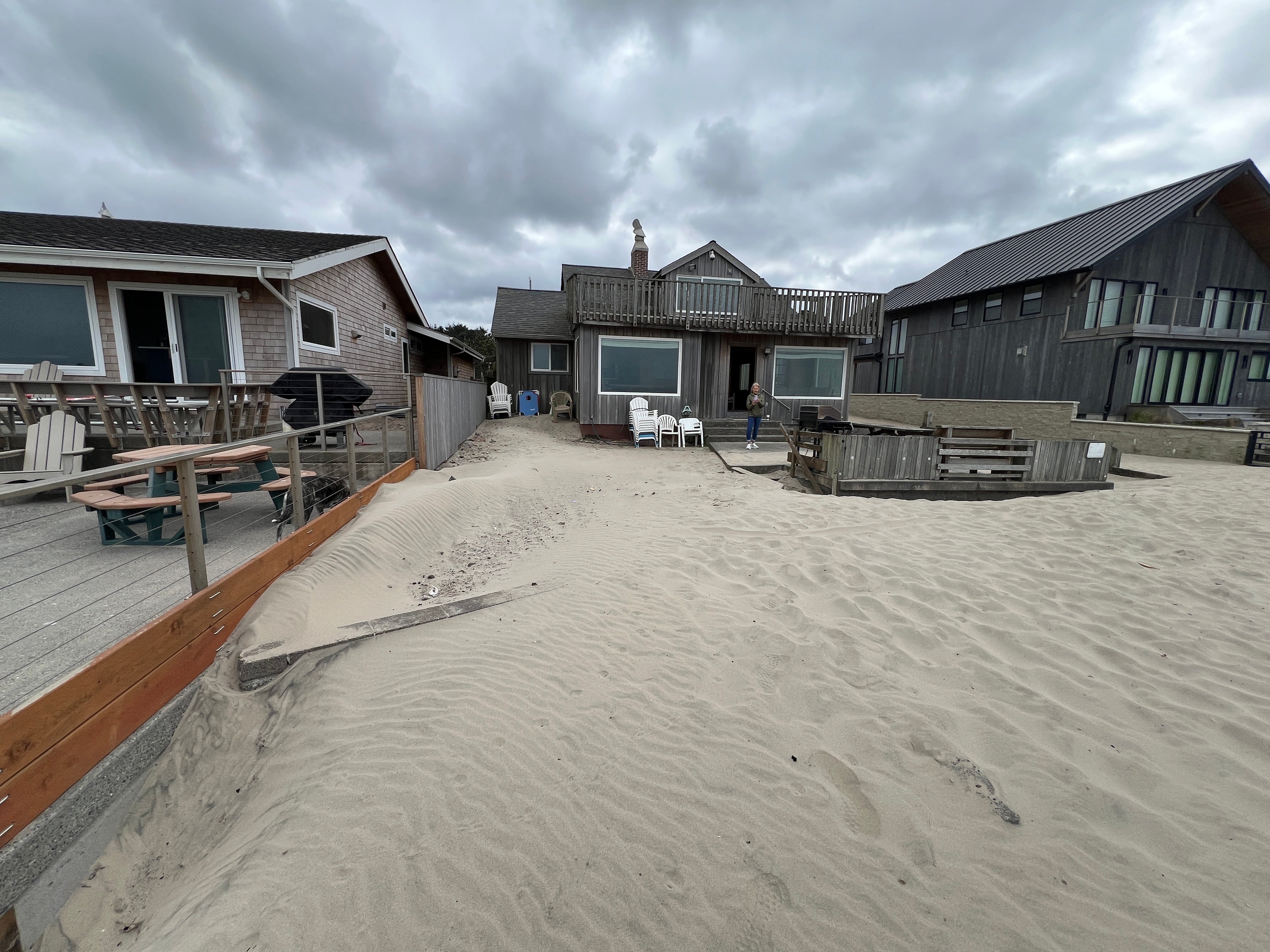 Sand stretches to the Niedermeyer family’s beach house after burying a seawall in Cannon Beach, Oregon