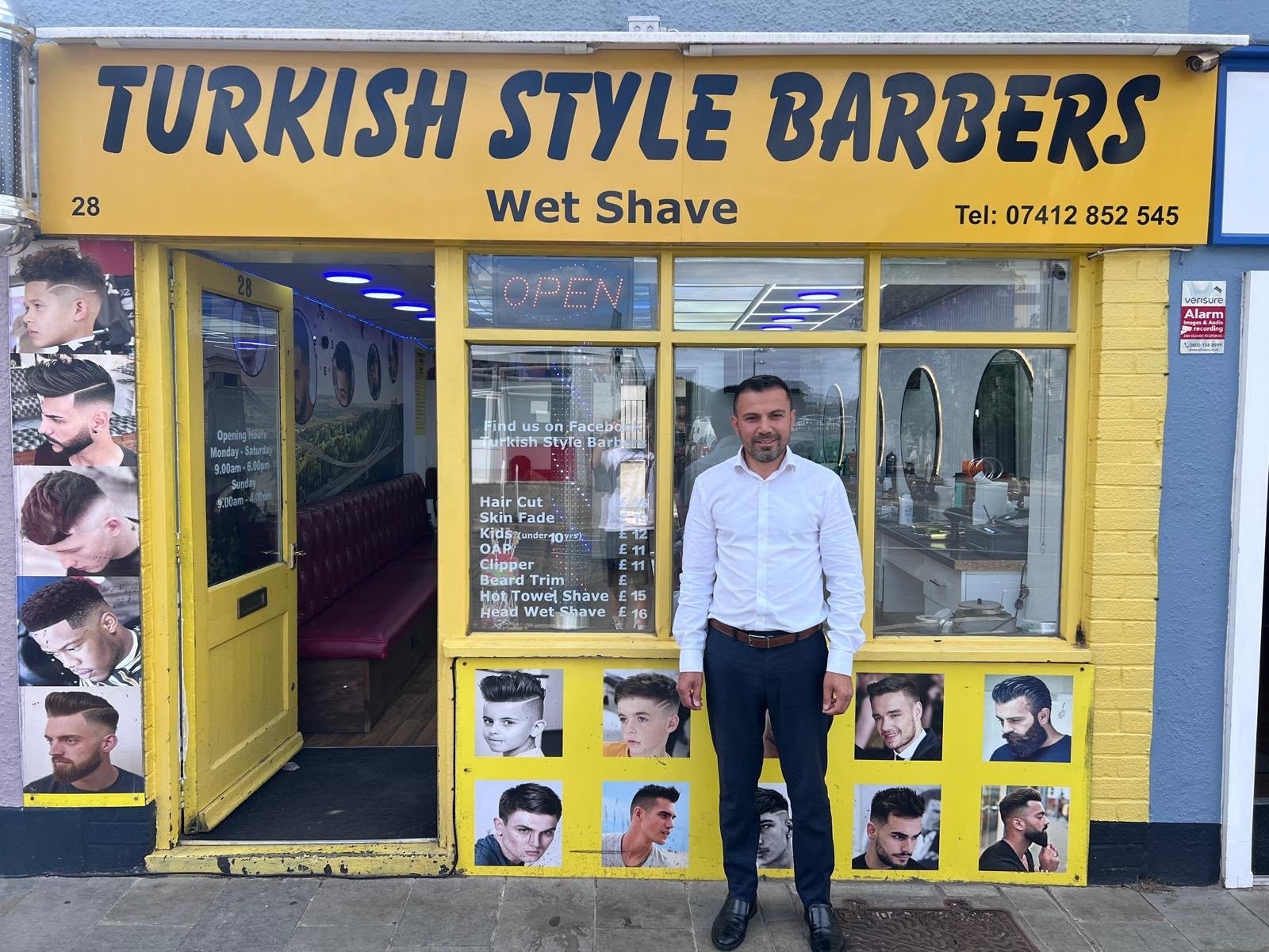 Alan Ahmae outside his barber shop in Keynsham near Bristol