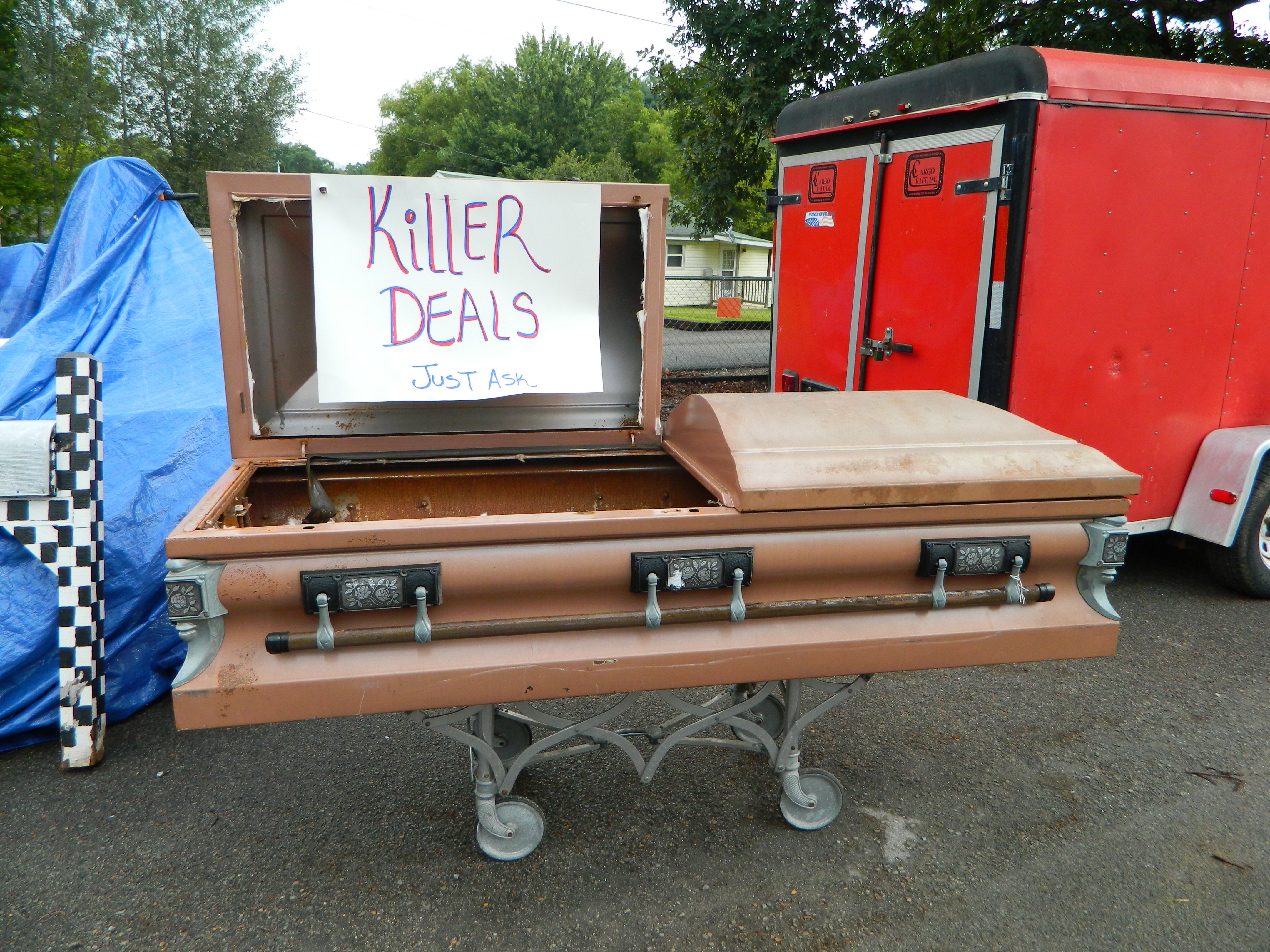 A roadside sign propped inside an open casket promises a ‘killer deal’ along a 700-mile stretch of rural back roads