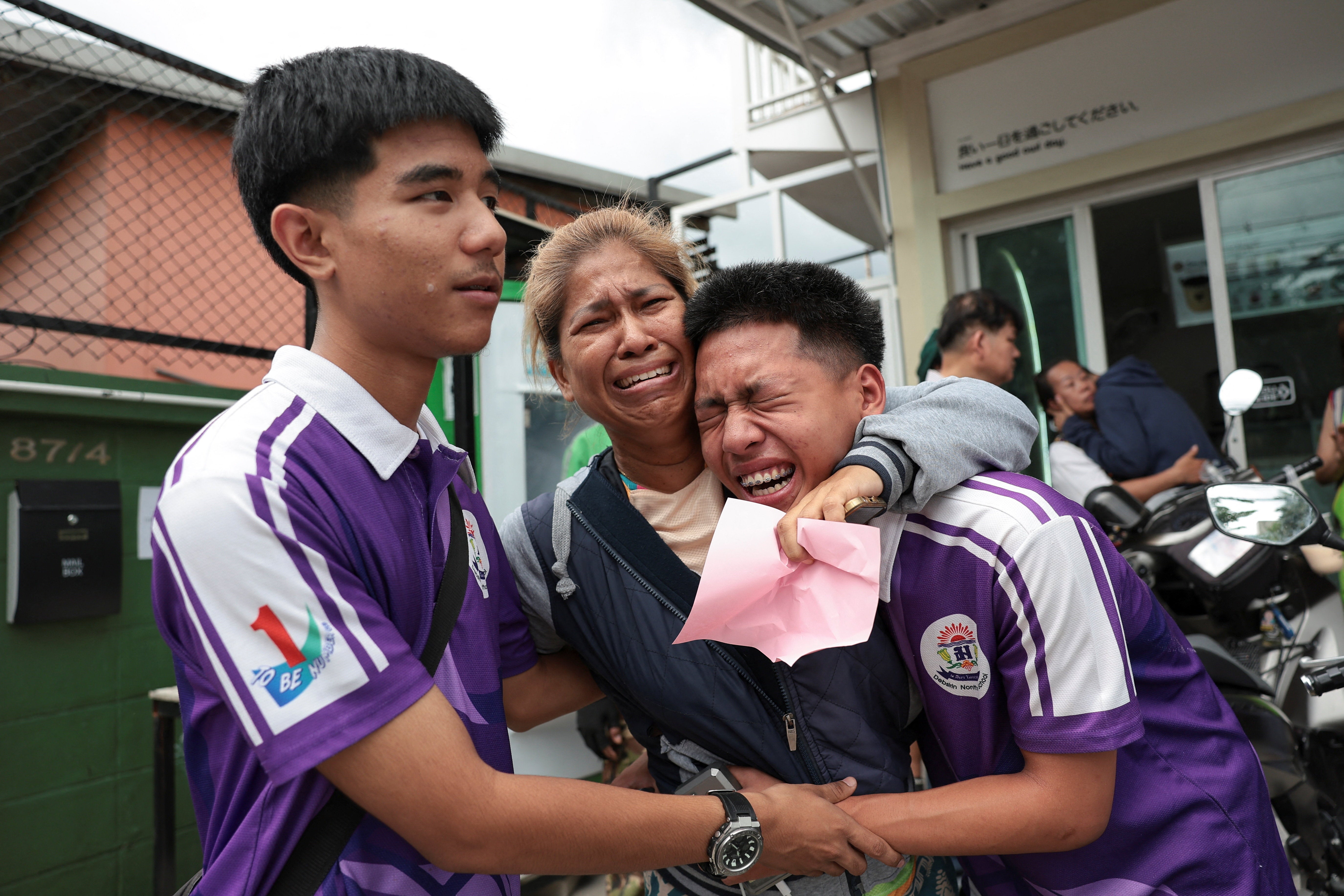 Students react with a relative after being evacuated from Debsirin Nonthaburi School, the site of a shooting incident, in Bang Kruai district in Nonthaburi province on the outskirts of Bangkok (Reuters)