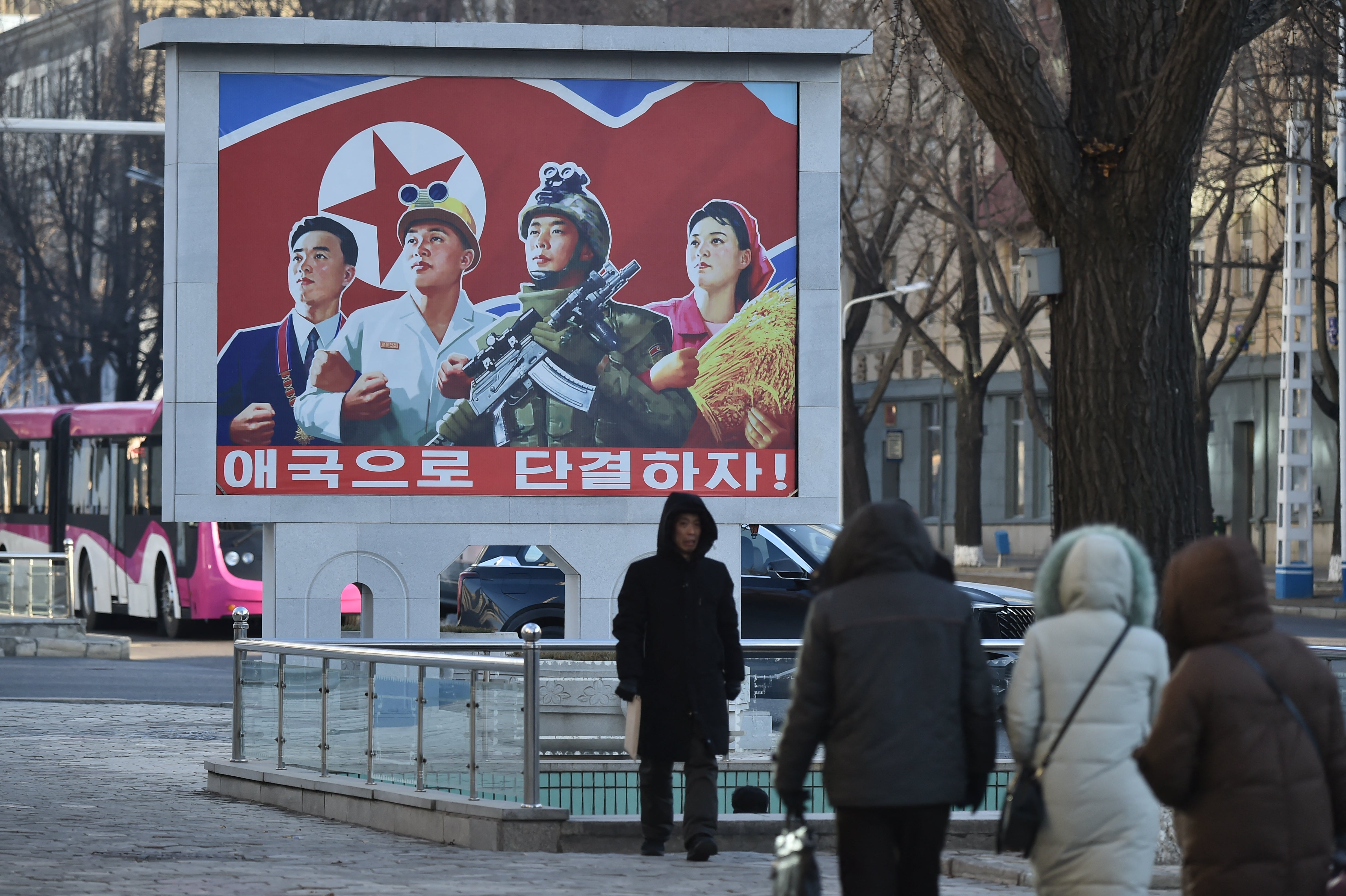 People walk in the street amid cold weather in Pyongyang on January 20, 2026