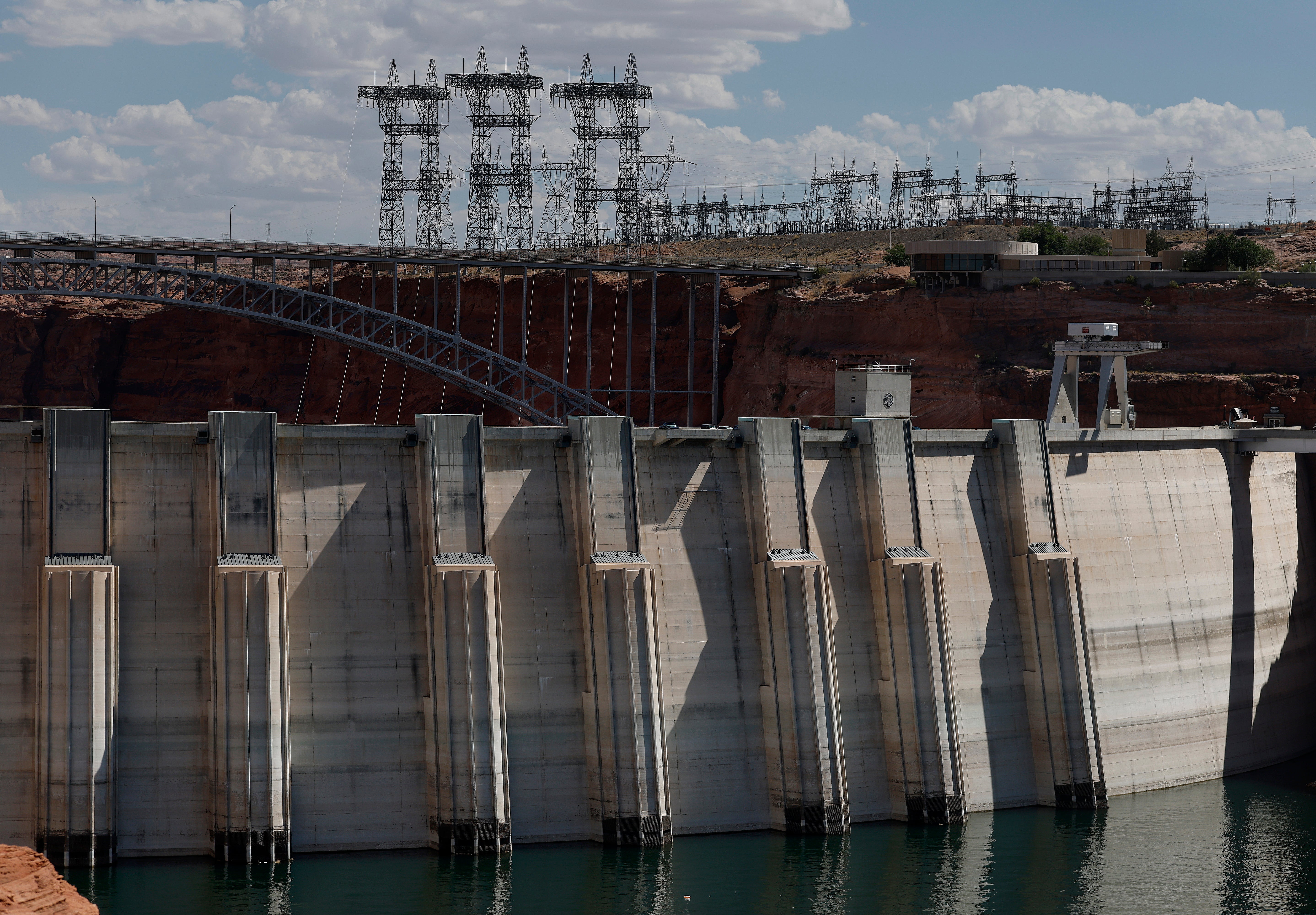 High-voltage transmission towers stand over the Glen Canyon Dam on July 31