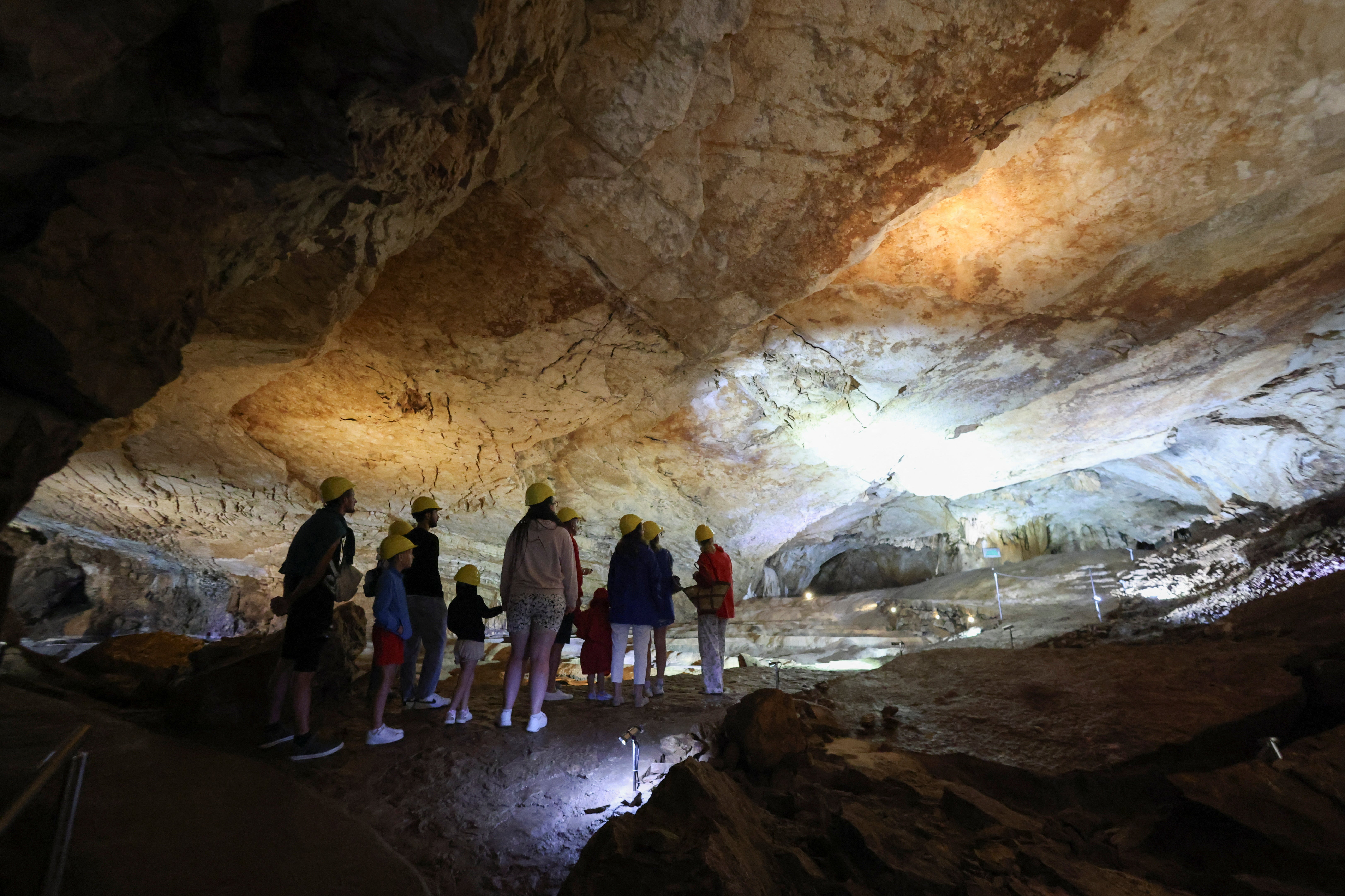 Tourists visit Vjetrenica Cave, a UNESCO World Heritage Site, where temperatures remain a constant 11 degrees to escape the summer heat