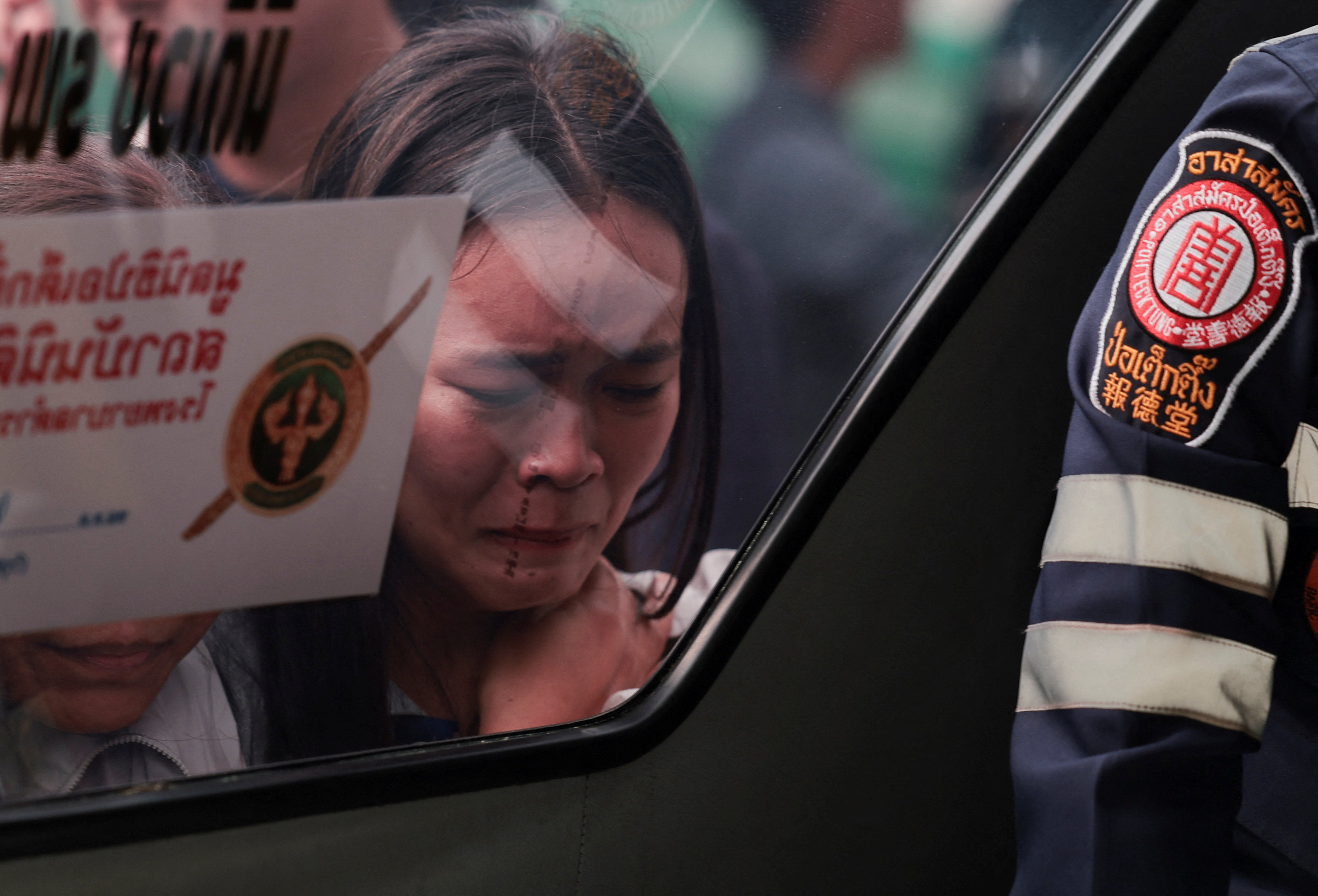 The relative of a victim reacts while looking at the victim's dead body