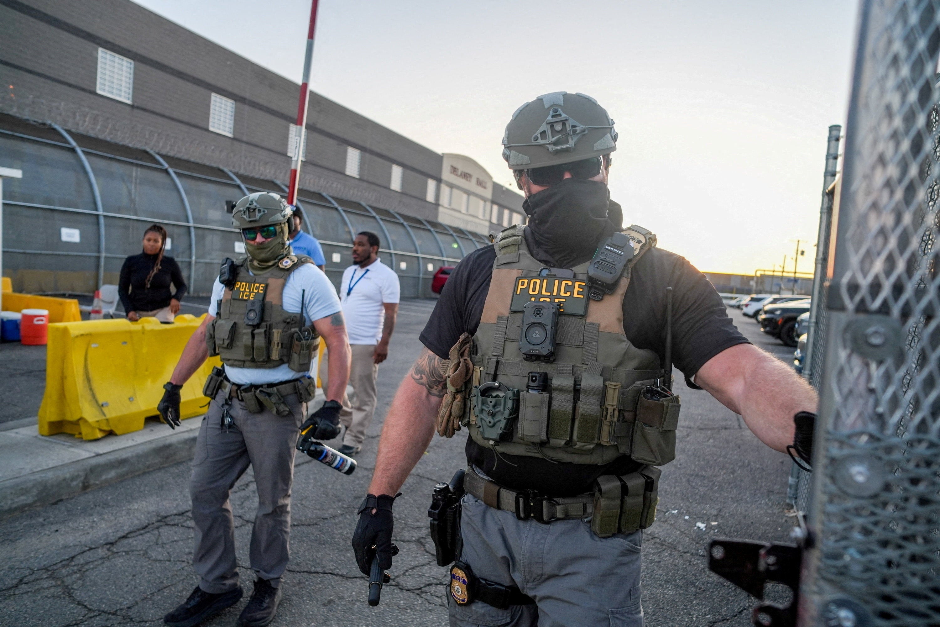 Immigration and Customs Enforcement (ICE) agents walk to close a gate outside of Delaney Hall detention center, after a Salvadoran immigrant, Edwin Lopez-Cornejo, who was being held inside died (Reuters)