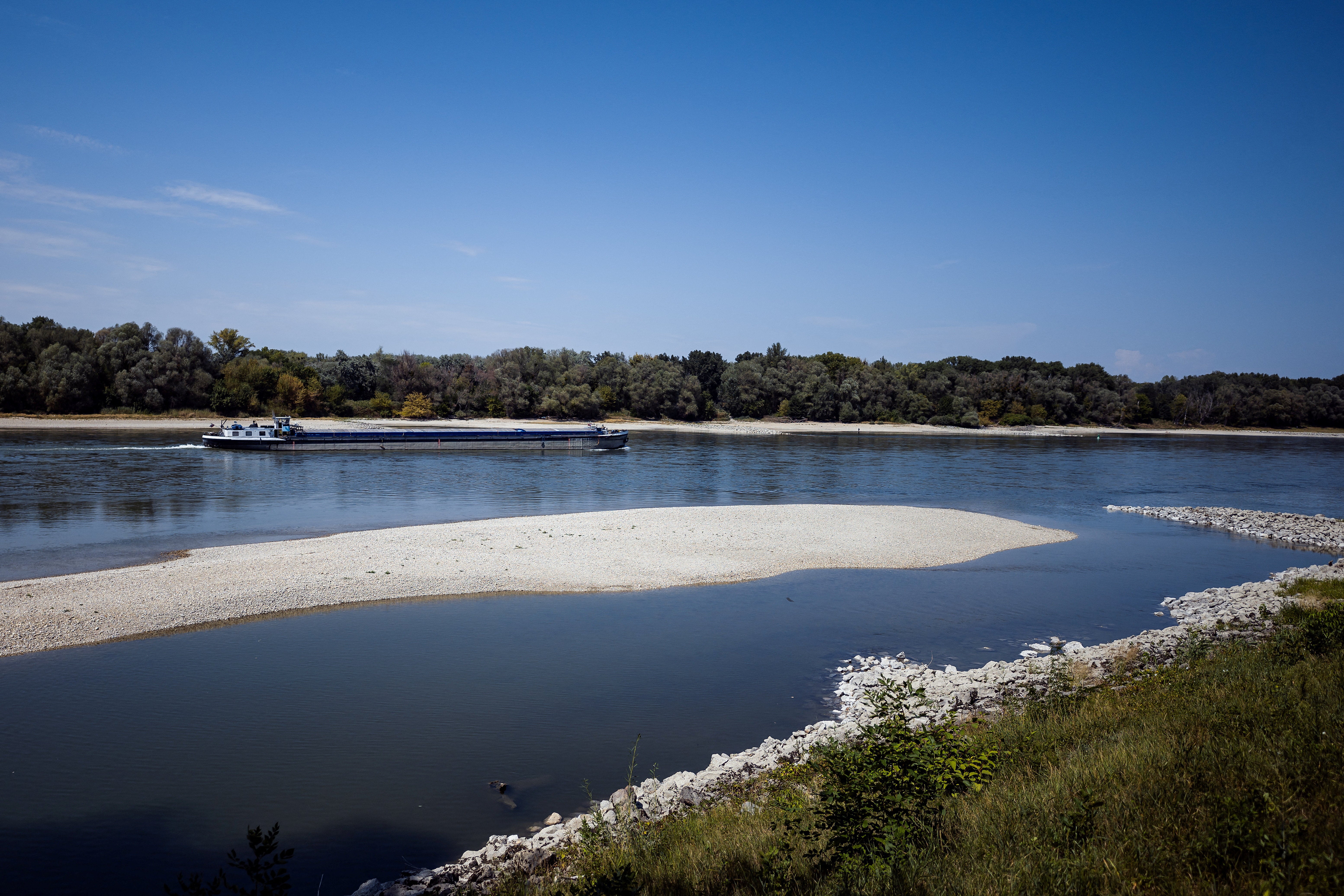 A ship travels upriver in the low water of the Danube River during a heatwave near Bad Deutsch-Altenburg an der Donau, Austria, 6 August 2026