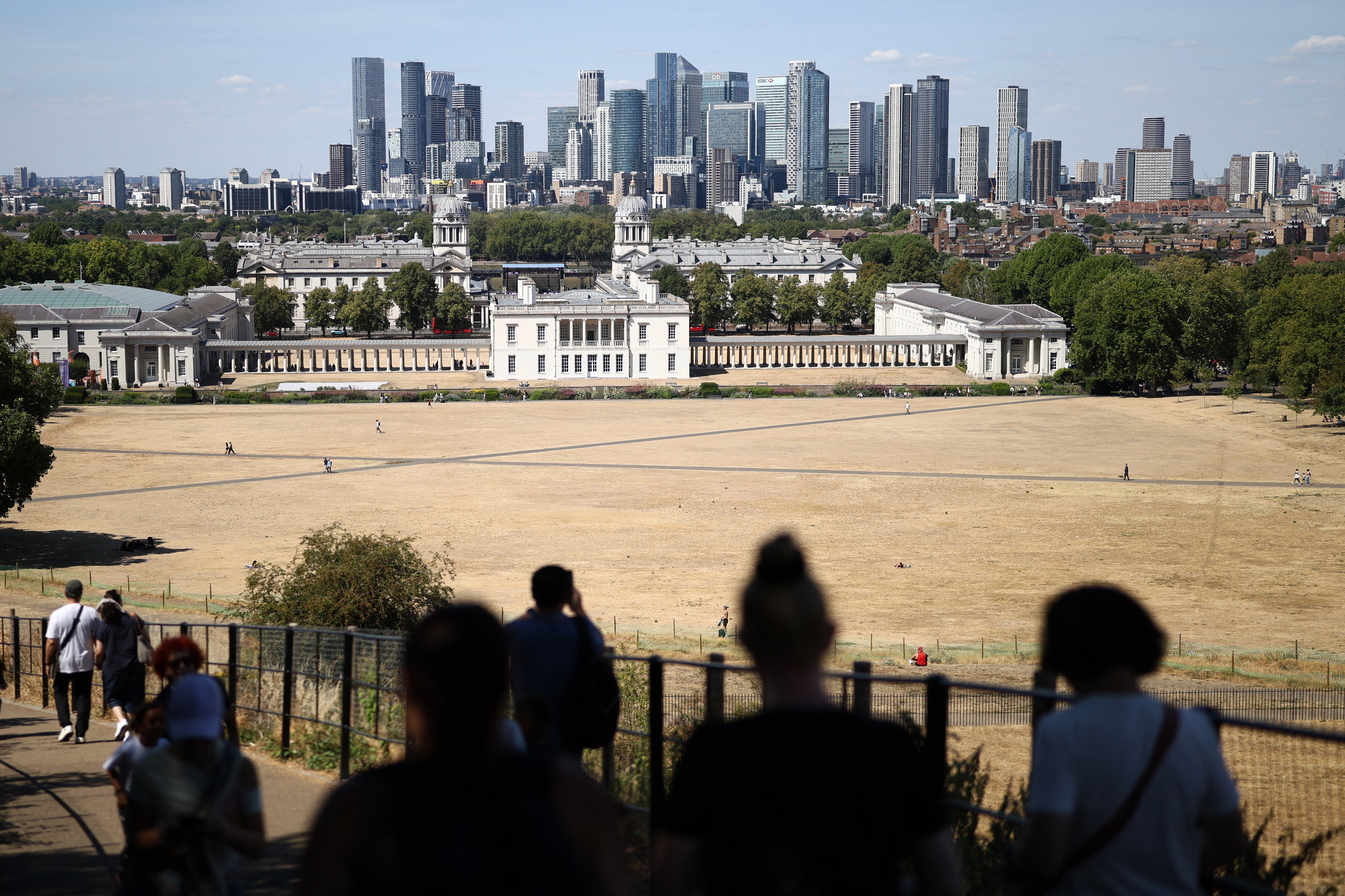 People walk on a path between the sun scorched grass, turned yellow-brown by a lack of rain, in Greenwich Park (AFP/Getty)