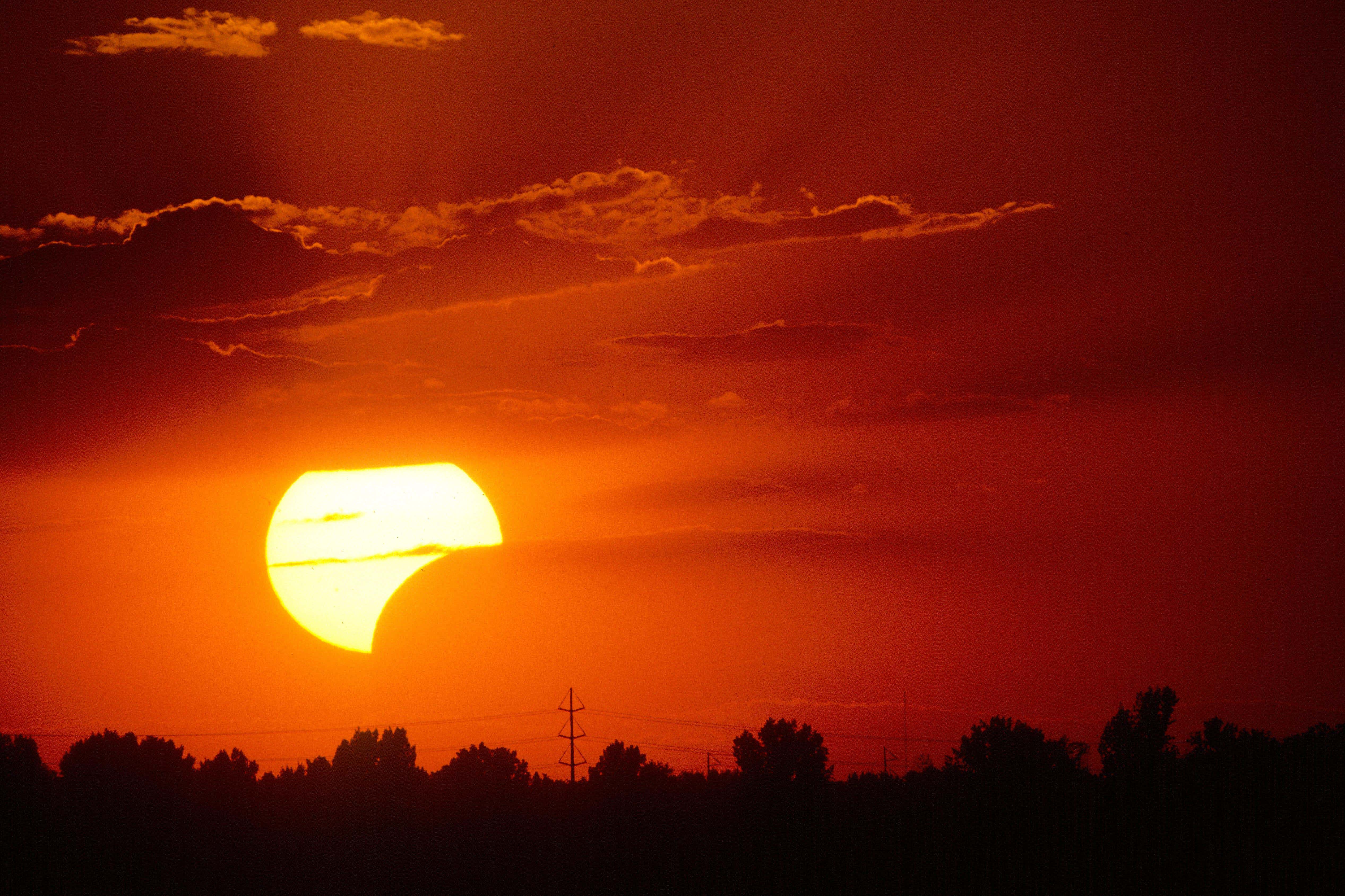 A partial solar eclipse is seen over Boise, Idaho. A partial solar eclipse happens when there is not a full alignment of the sun, moon and Earth (Alamy/PA)