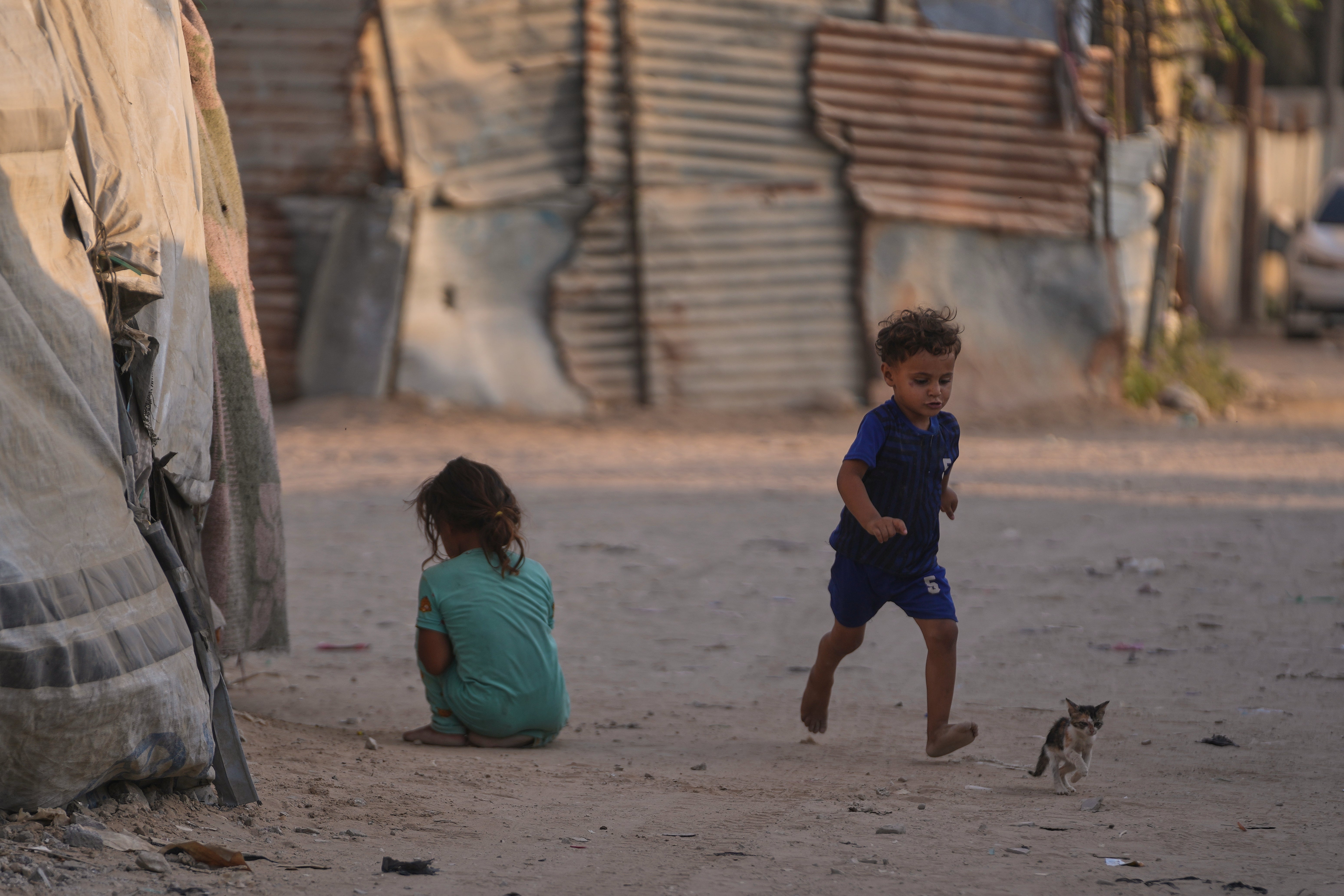 Children play among the tents at a camp for displaced Palestinians in Deir al-Balah, central Gaza Strip