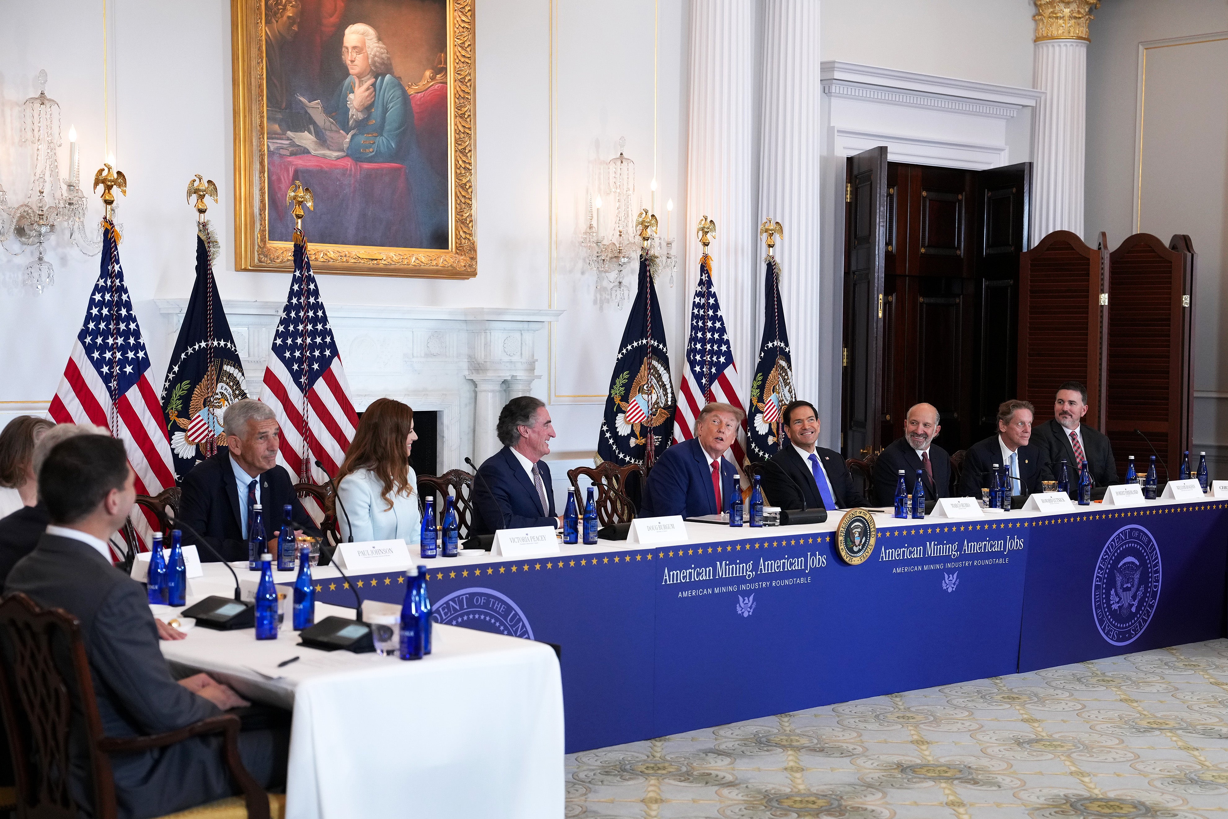 President Donald Trump admires the decor in the room during a roundtable on the American mining industry at the US Department of State in Washington, DC