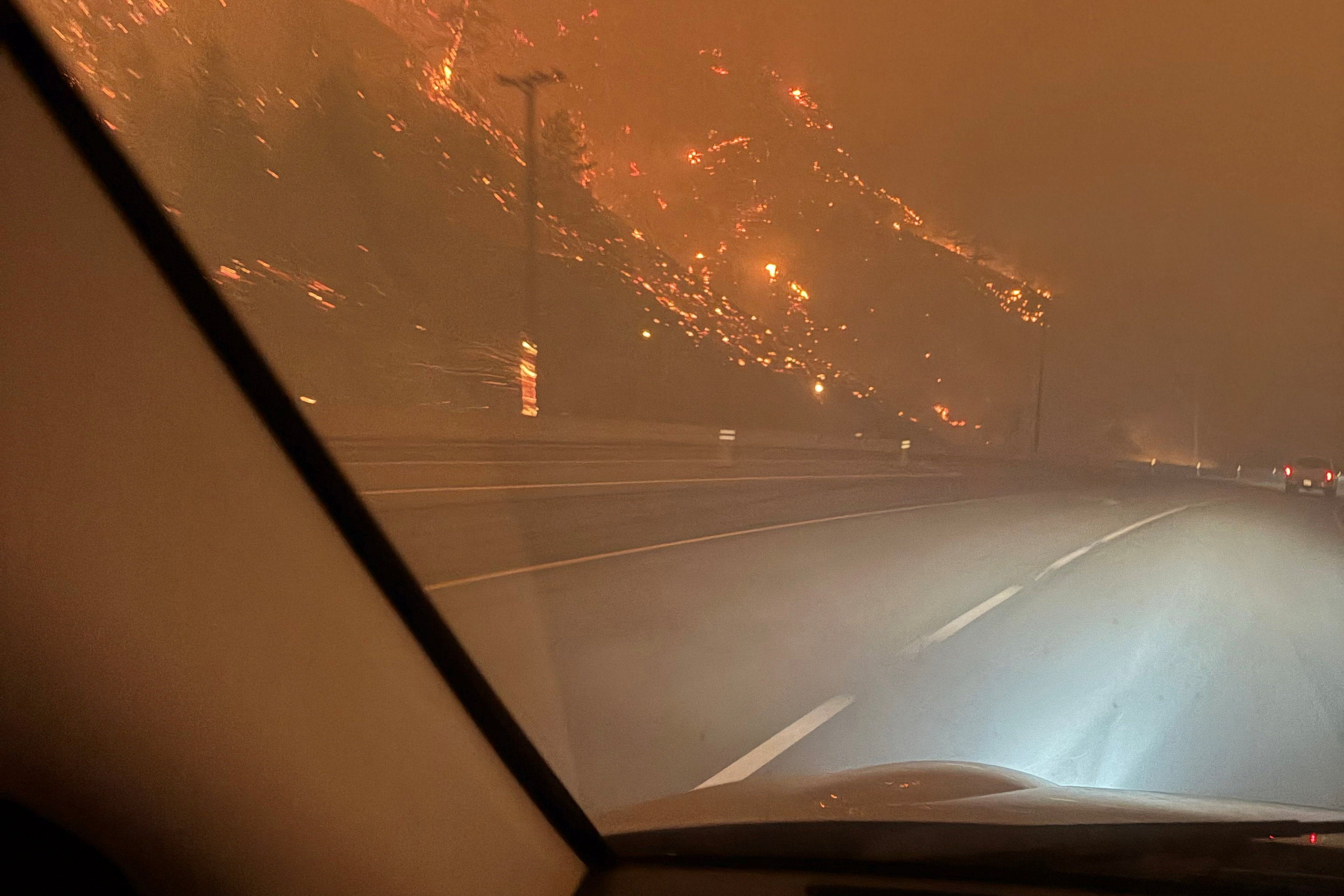 The hillside burns as residents evacuate towards Kelowna after midnight