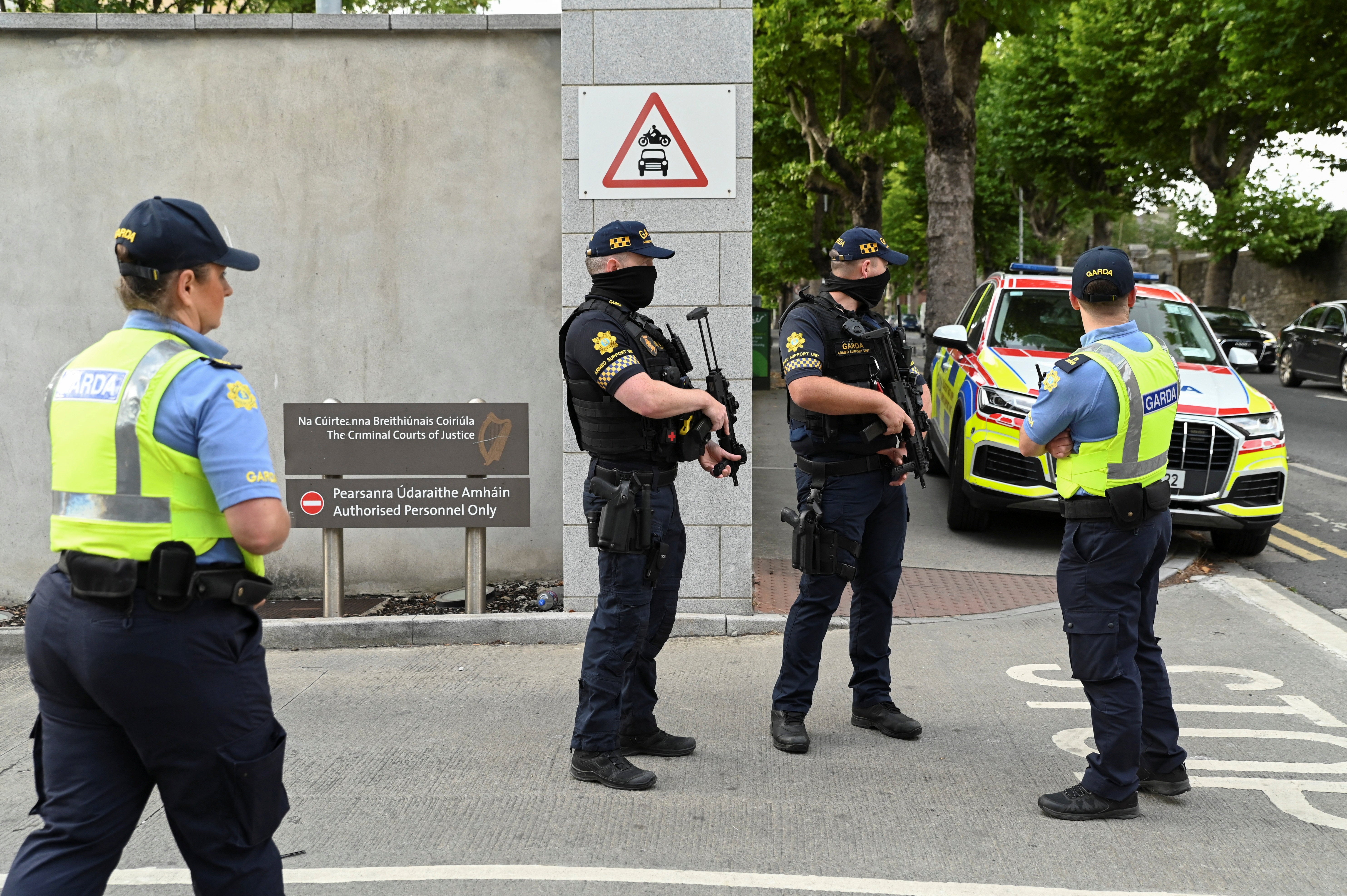Members of the Garda stand outside the Special Criminal Court in Dublin (Reuters)