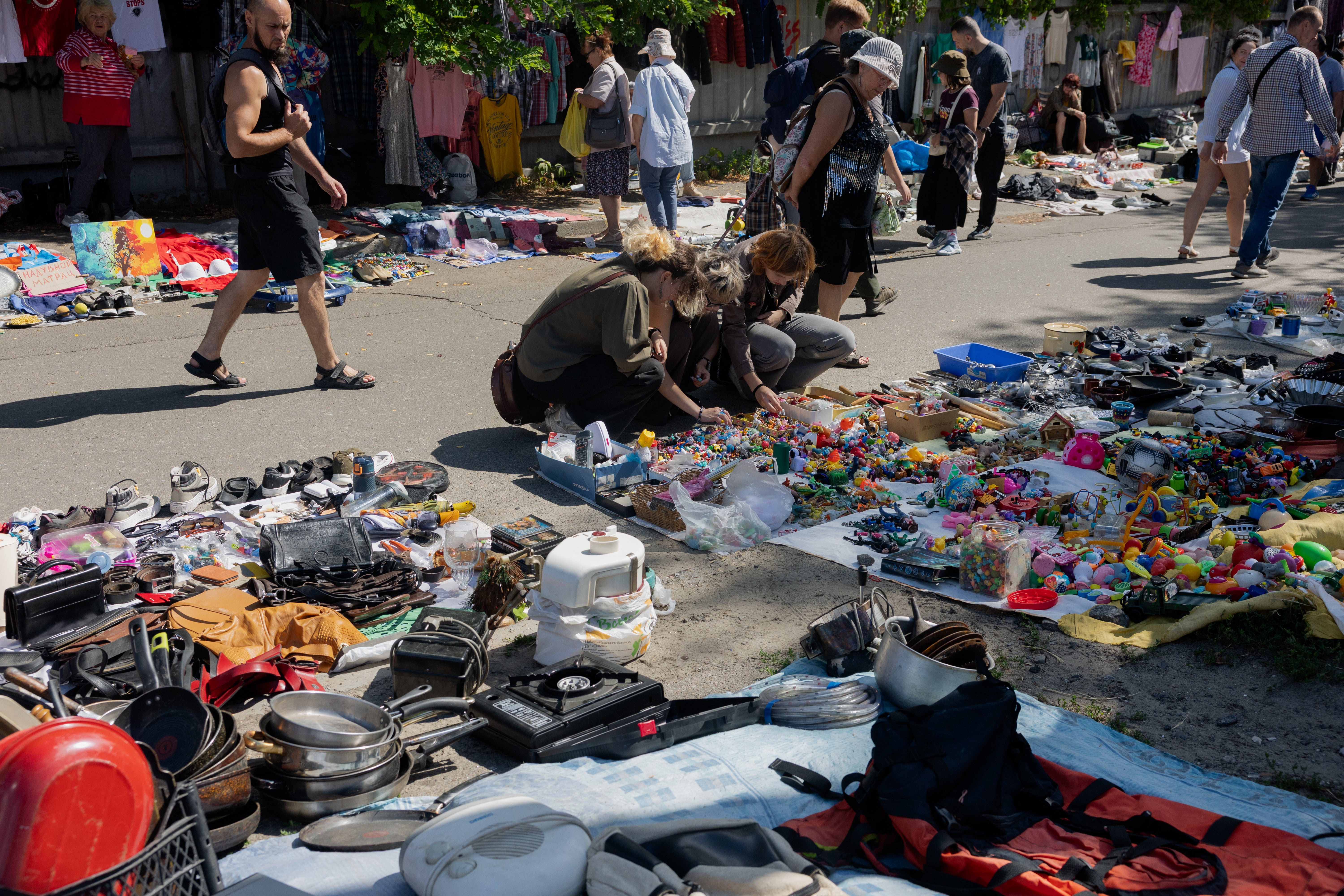 People look at the goods on a stall of a vendor at a damaged street market following Russian strikes in Petrivka neighbourhood in Kyiv (AFP/Getty)