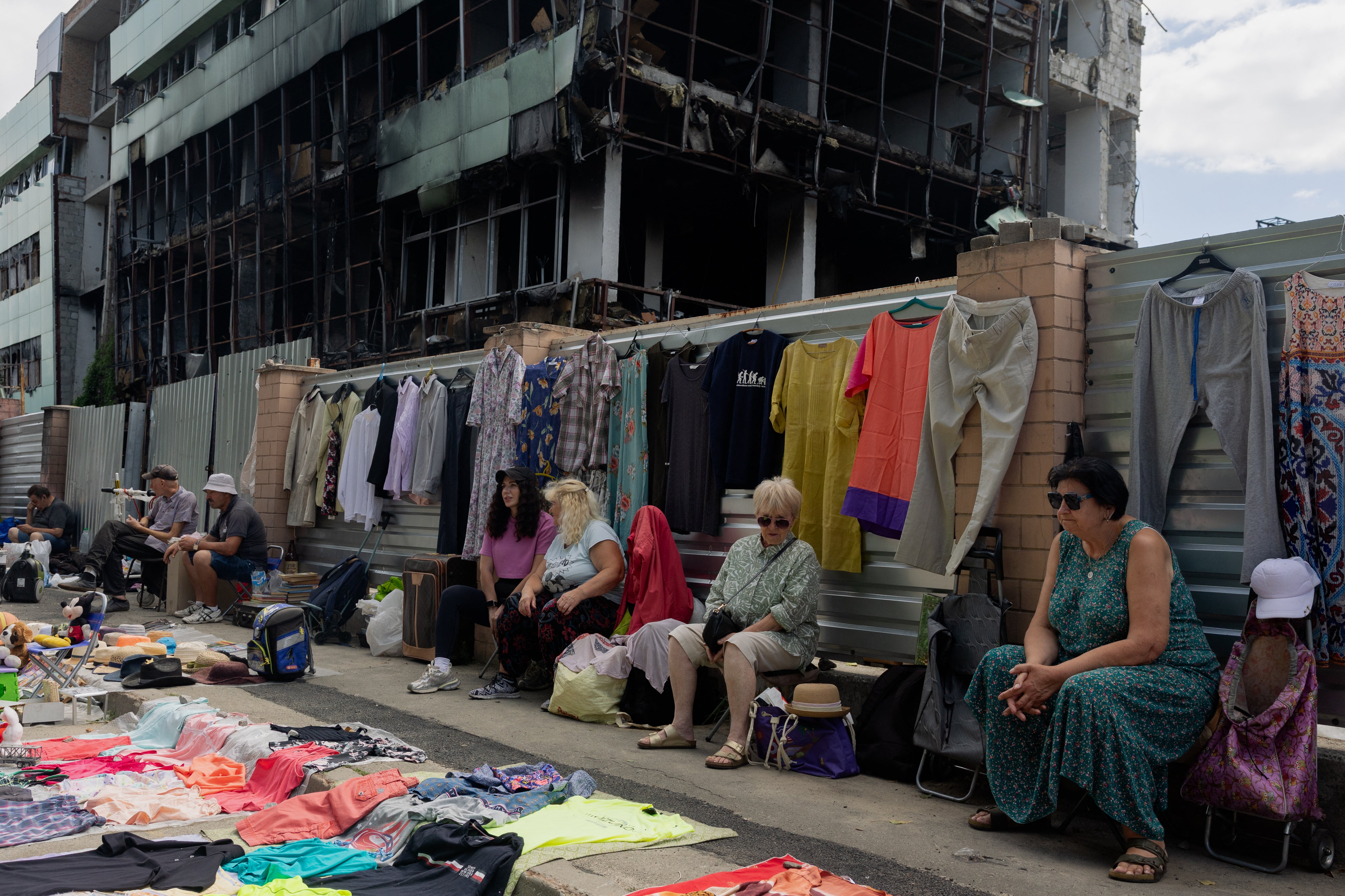 vendors sit in front of their stalls at a damaged street market following strikes in Petrivka, one of Kyiv's neighborhoods (AFP/Getty)