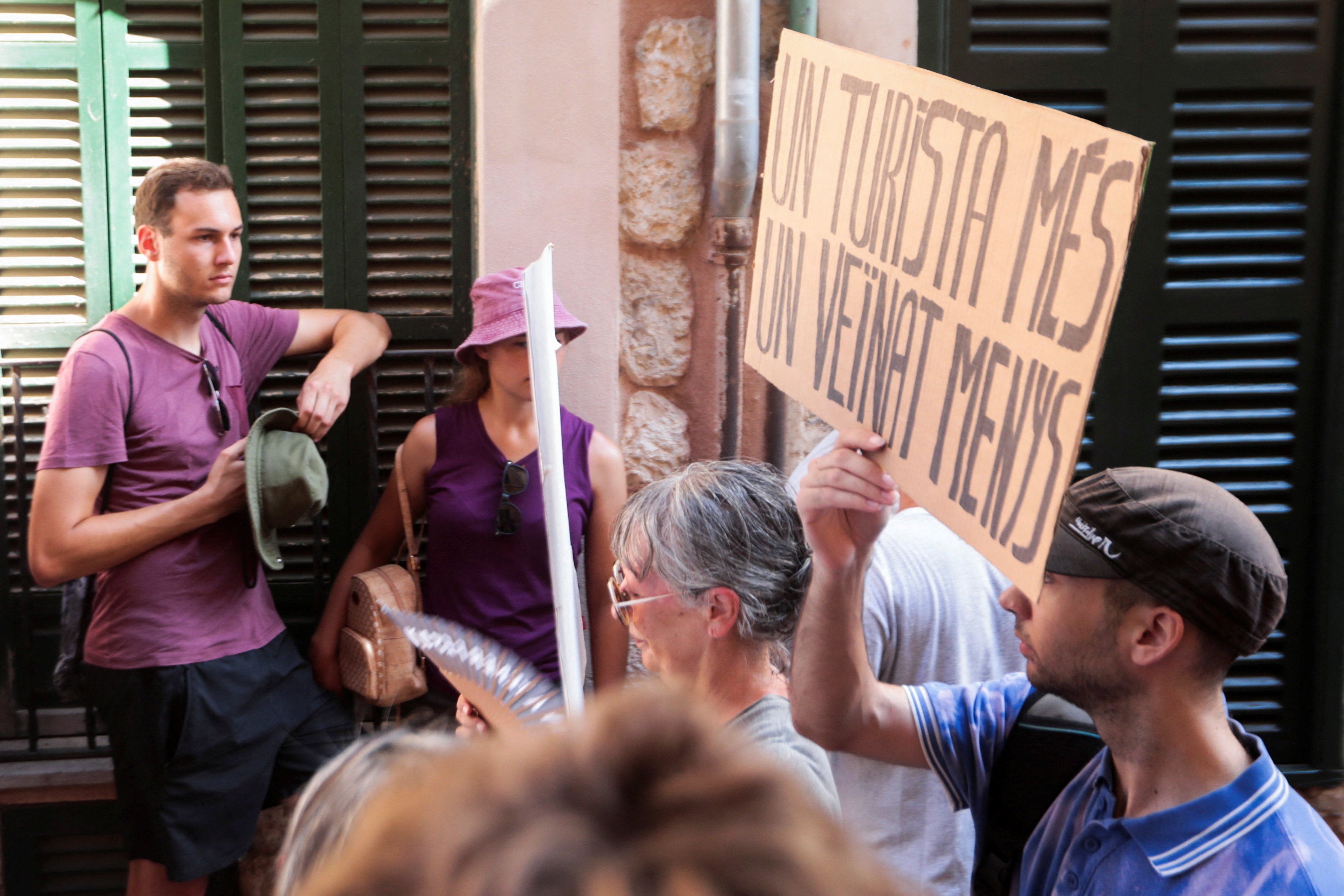 A demonstrator holds a sign that reads 