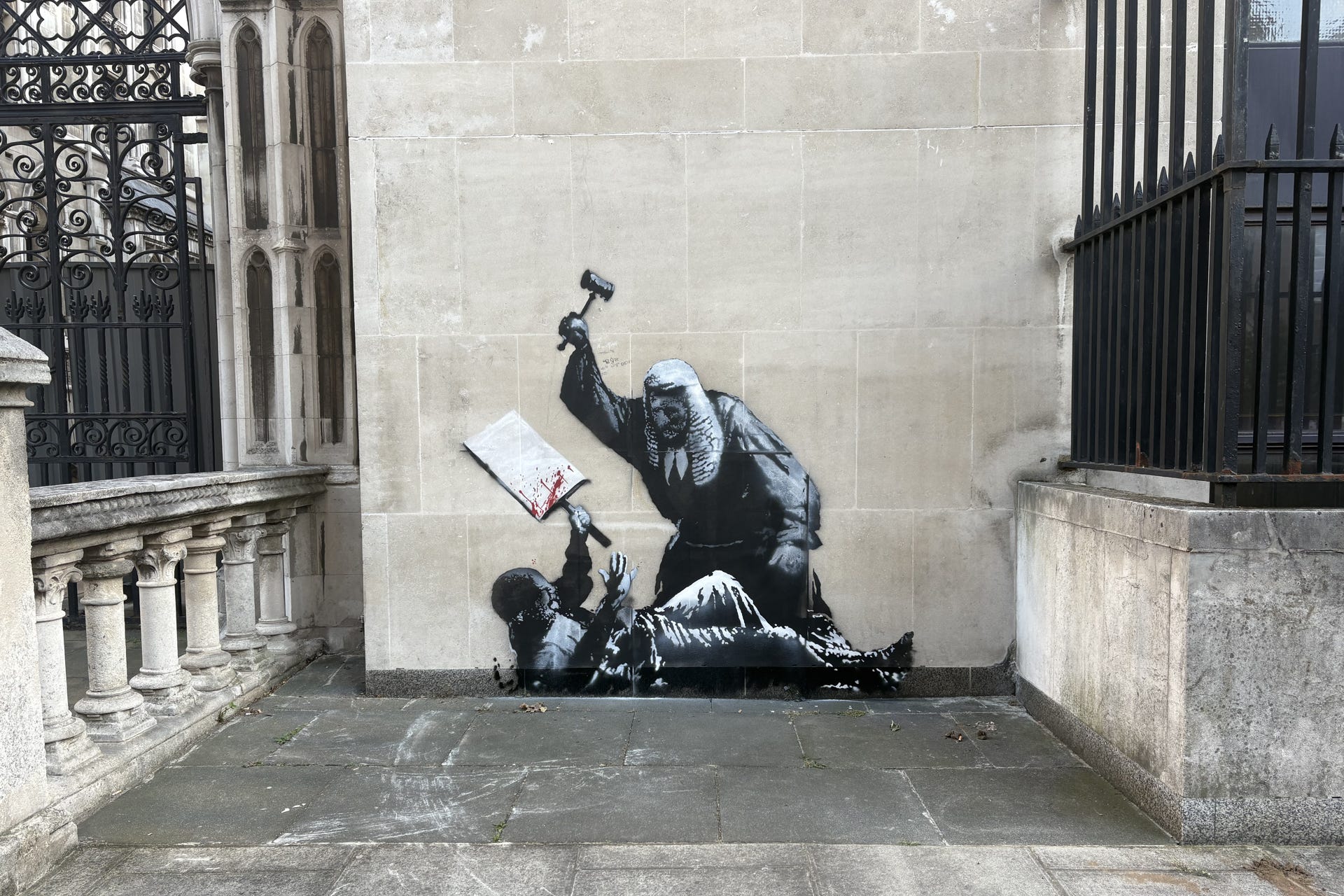 An artwork by Banksy at the Royal Courts of Justice in London which shows a judge attacking a protester with a gavel (PA Archive)
