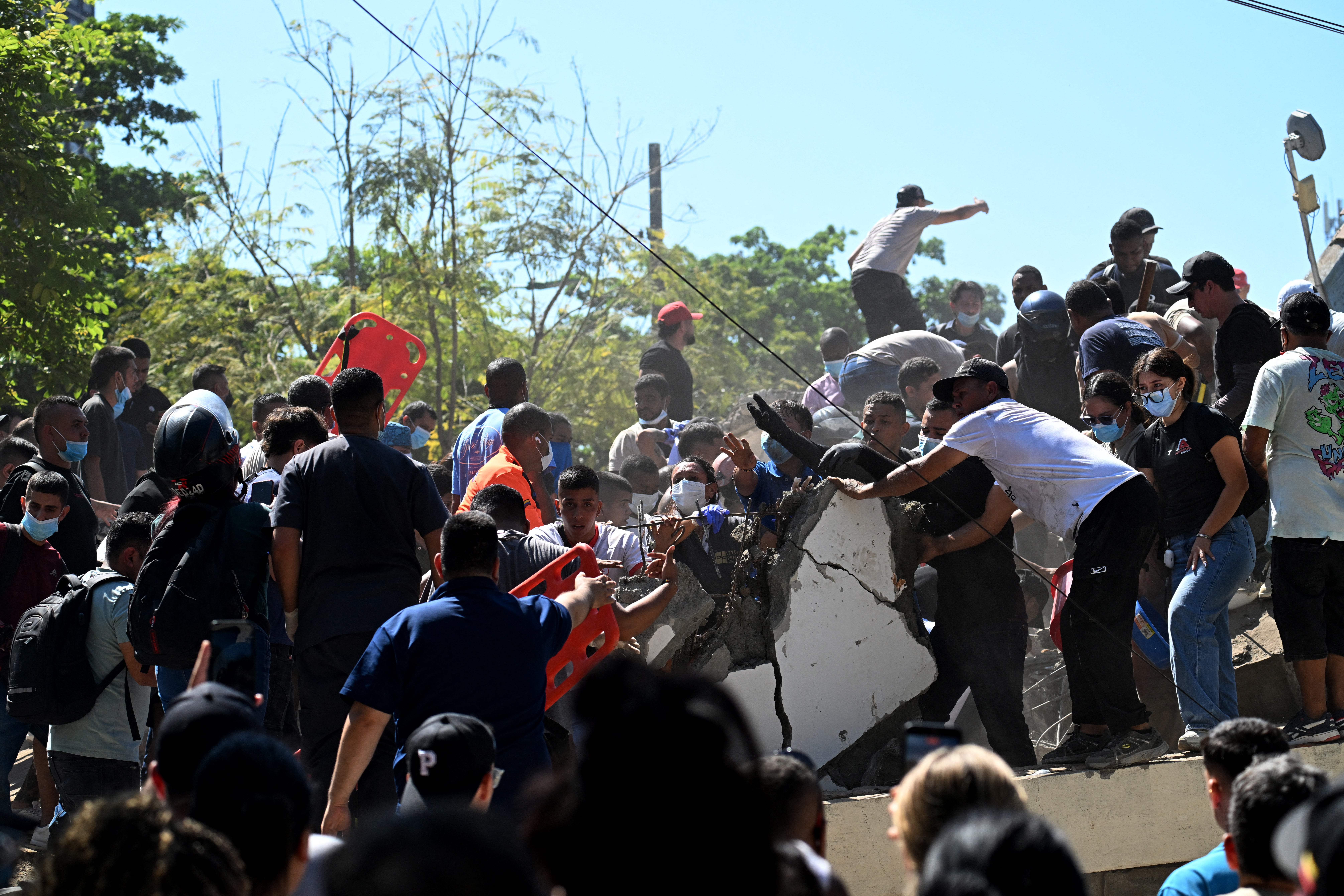 People look for survivors amid the rubble of a collapsed building after an earthquake in Cali, Colombia on August 10, 2026