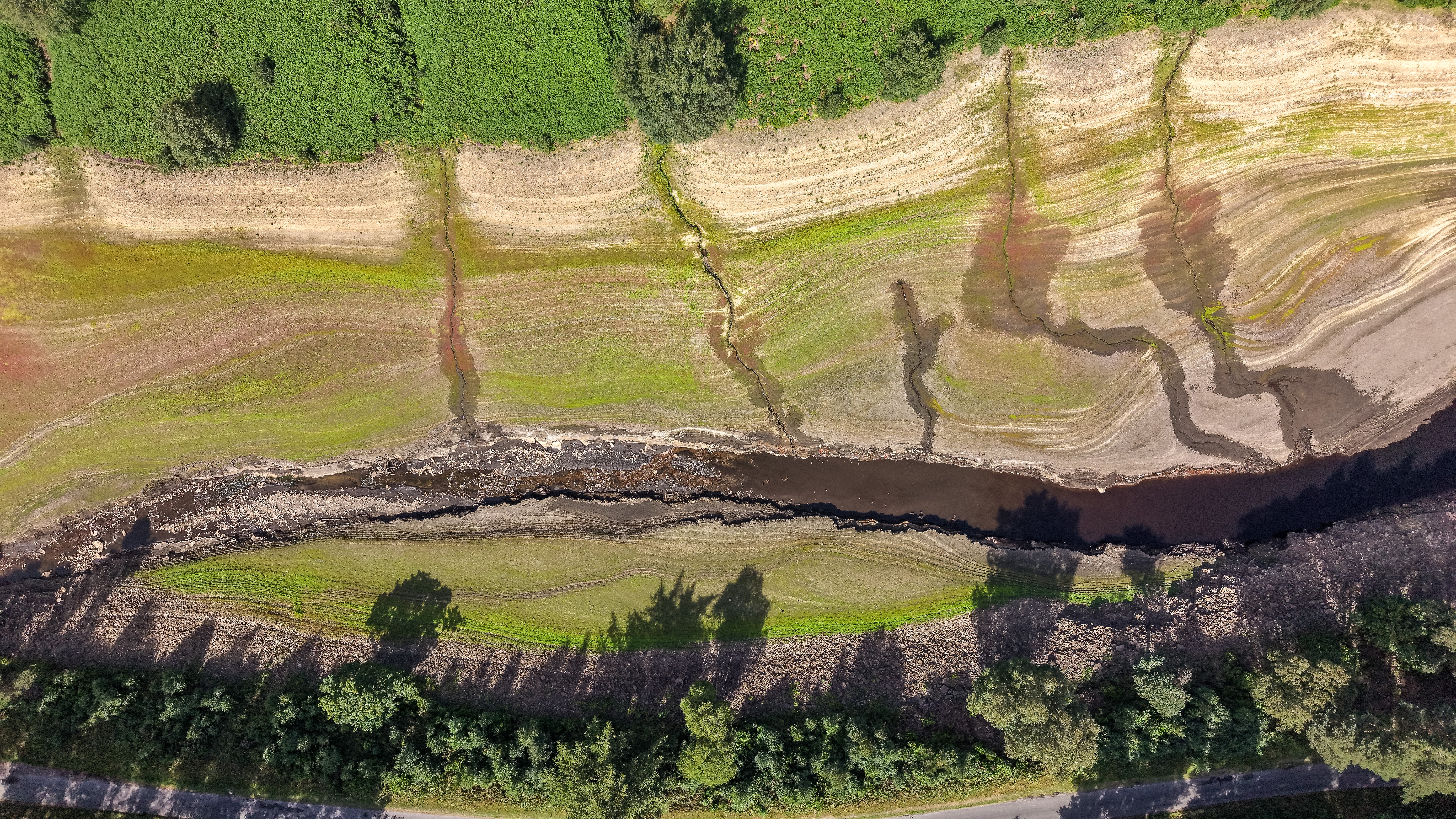 Low water levels reveal the reservoir bed of Howden Reservoir in Bamford