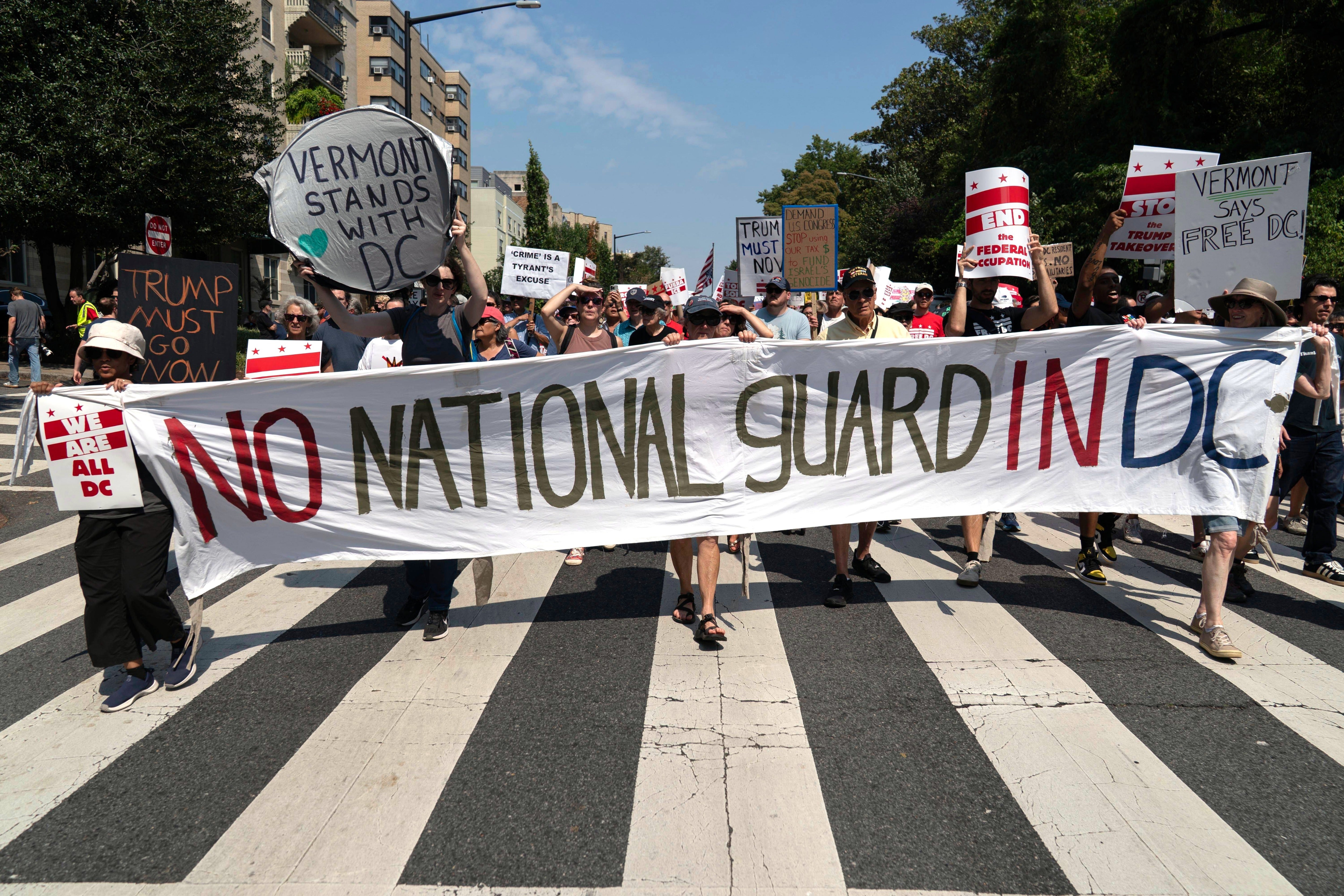 Demonstrators protest against Trump's deployment of federal law enforcement and National Guard troops during a march, Sept. 6, 2025, in Washington