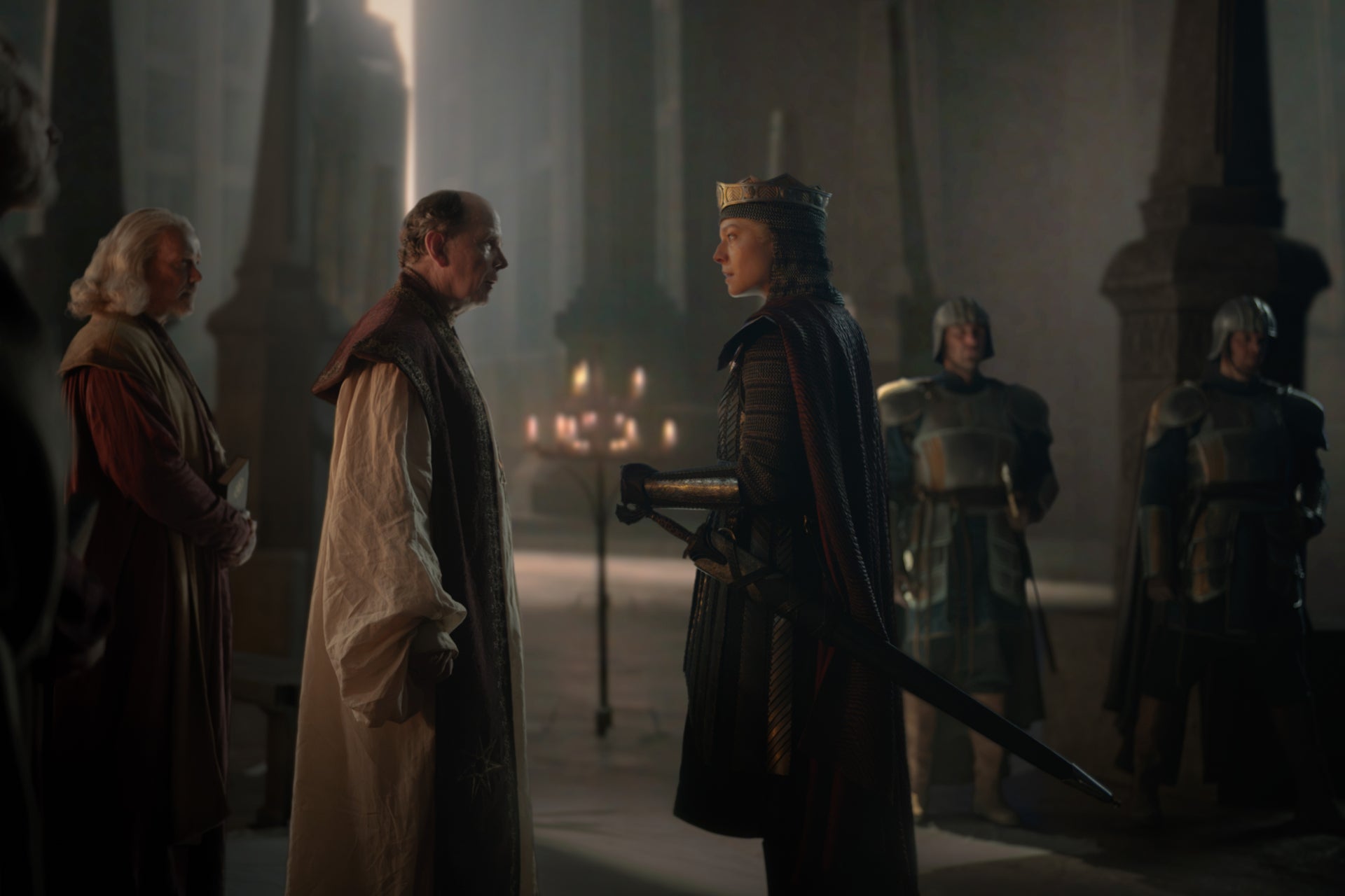 The High Septon (Simon Chandler) faces off against Queen Rhaenyra (Emma D'Arcy)