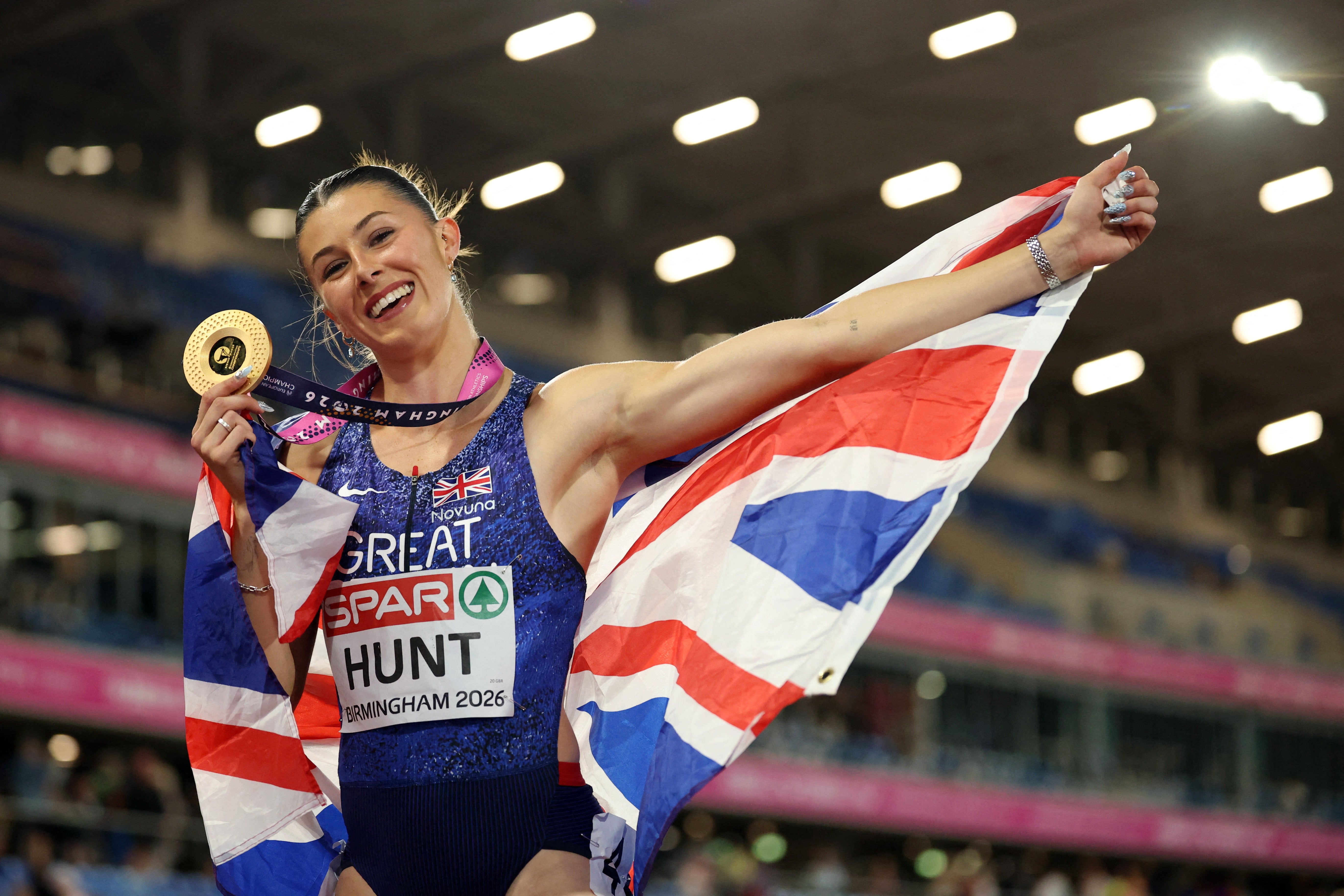 <p>Amy Hunt celebrates with her gold medal</p>