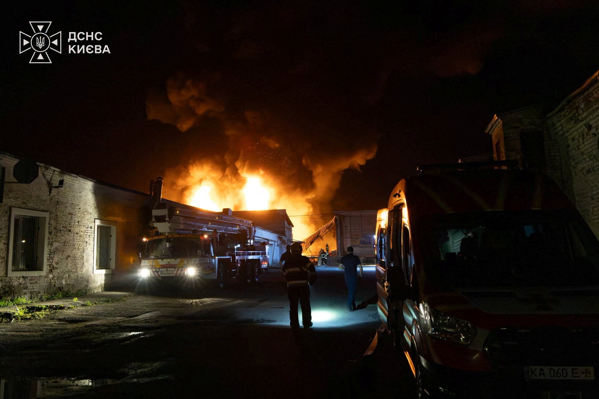 Firefighters work at a compound of a warehouse hit by an overnight missile strike, amid Russia's attack on Ukraine, in Kyiv