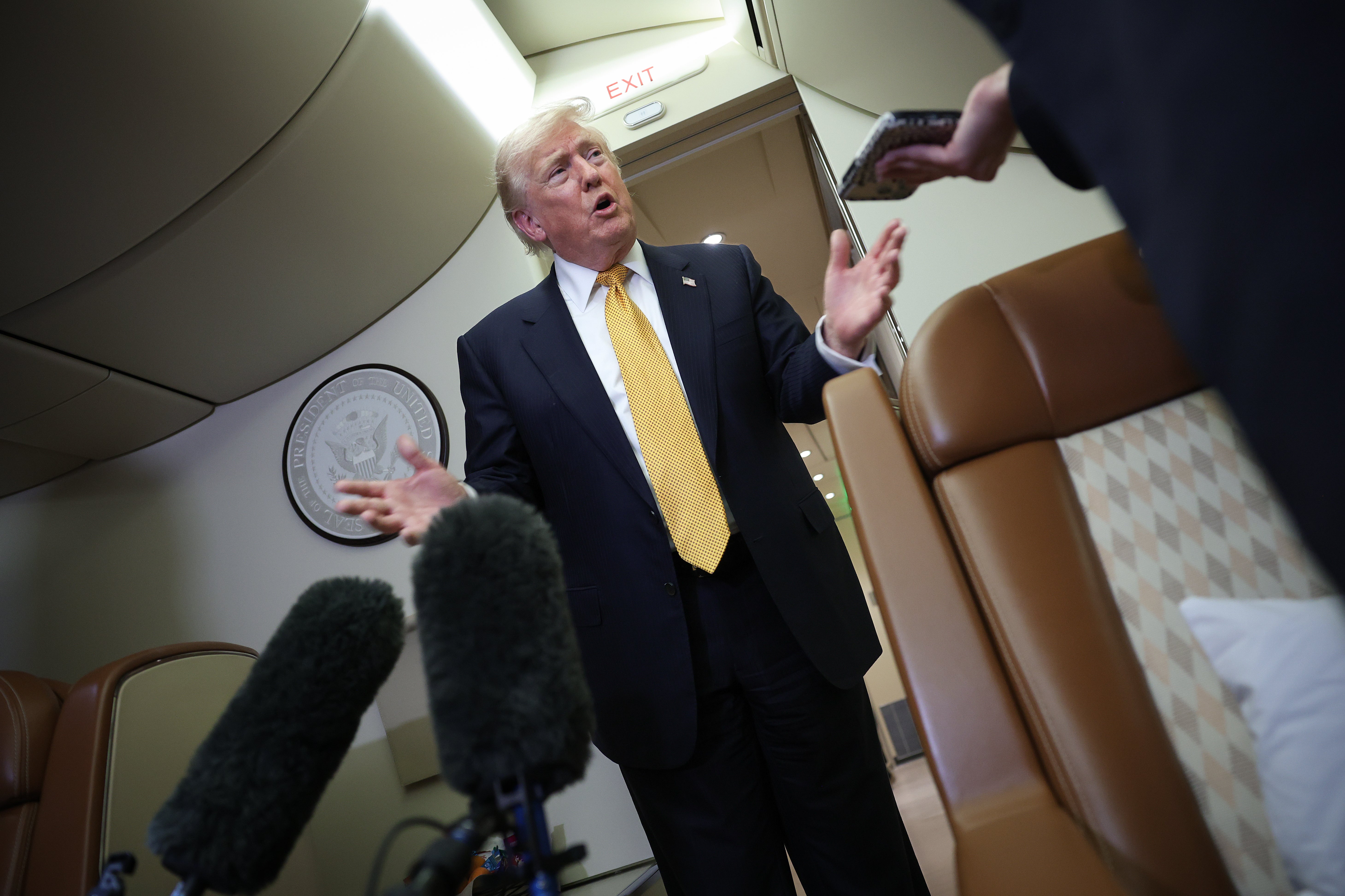 The president speaks to the press back on board Air Force One at RAF Mildenhall in eastern England before completing the final leg of the return journey to Washington