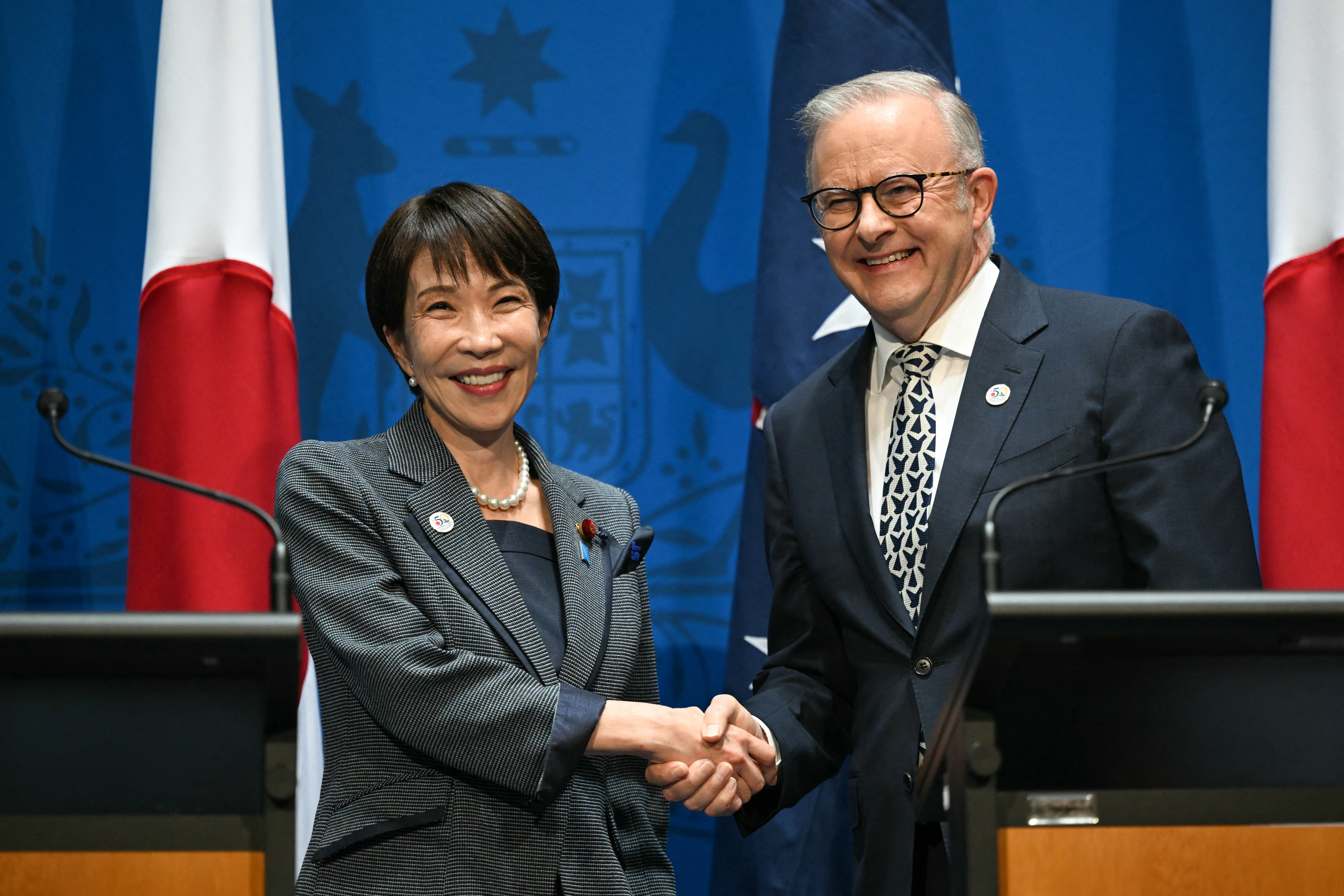 Anthony Albanese shakes hands with Japan’s Sanae Takaichi after speaking to the press in Canberra in May (AFP/Getty)