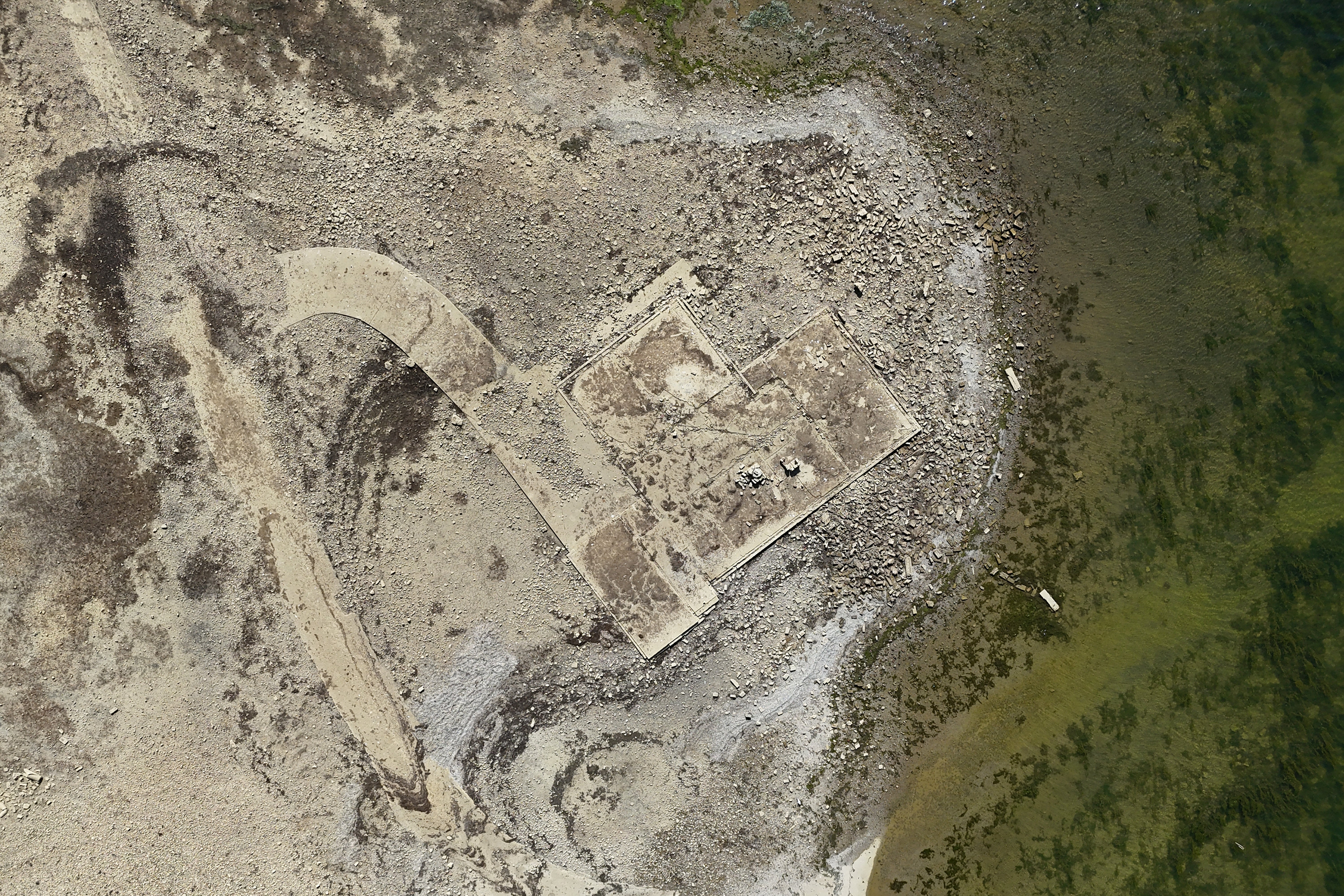 Remains of lost village uncovered as drought lowers reservoir levels in record-breaking heatwave