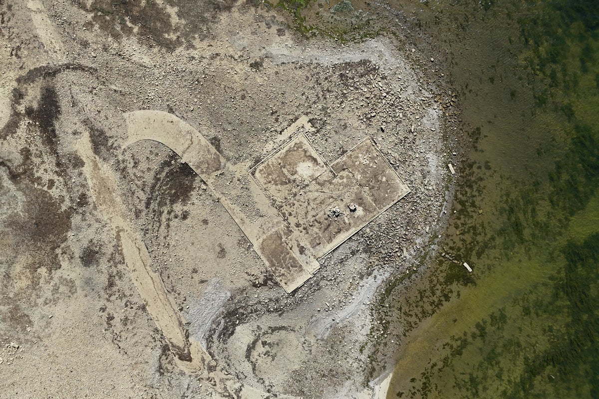 Remains of lost village uncovered as drought lowers reservoir levels in record-breaking heatwave