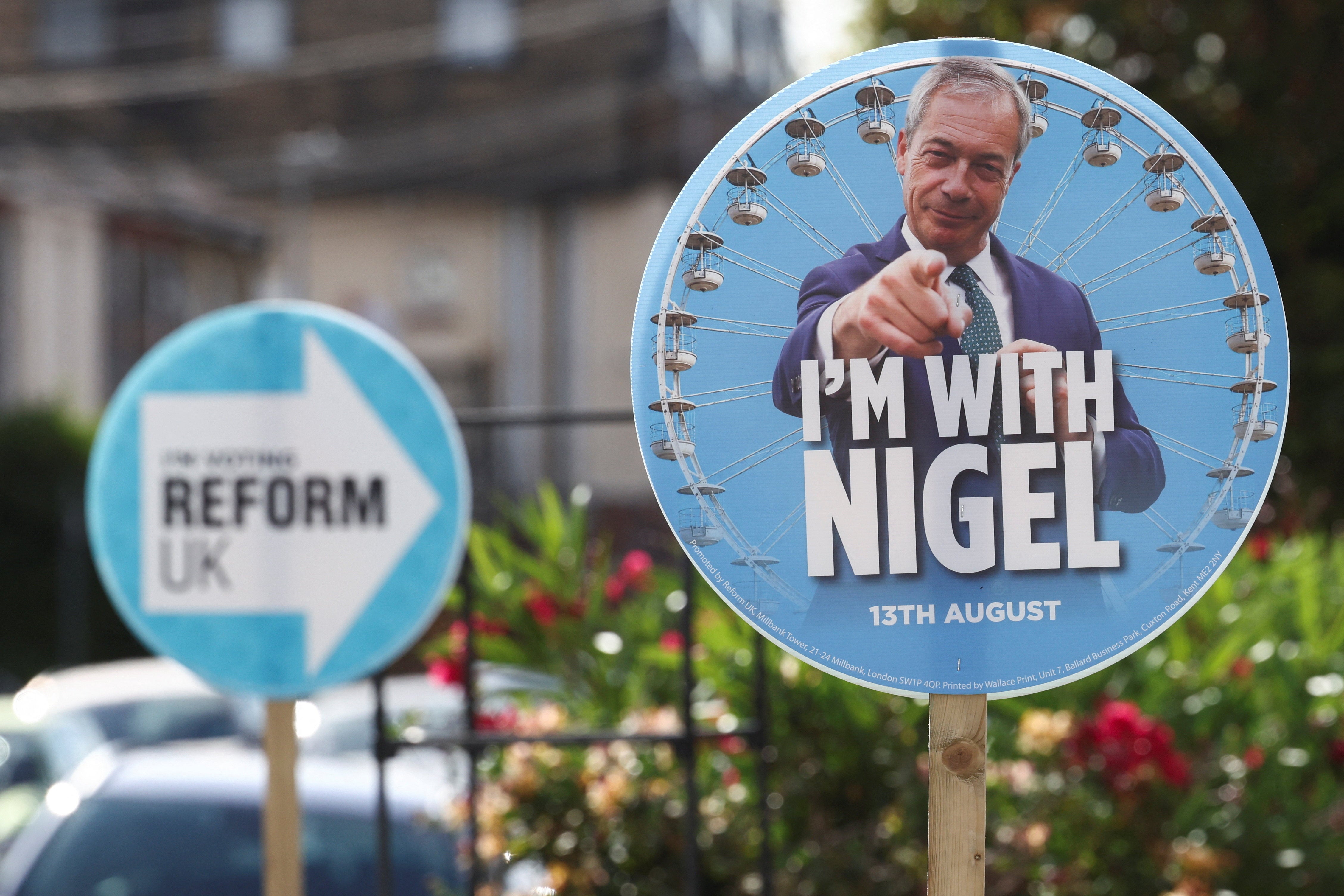 A Nigel Farage placard stands ahead of a by-election triggered by Reform UK party leader