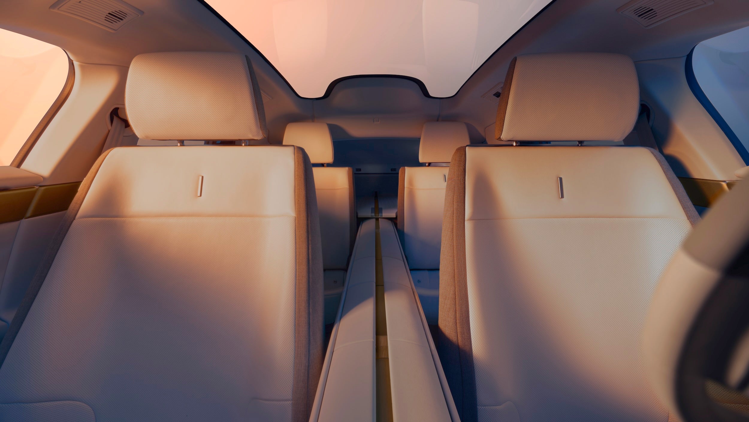 The Jaguar Type 01 features minimalist seats front and rear, a strong brass-trimmed centre spine, a long panoramic glass roof and no rear screen