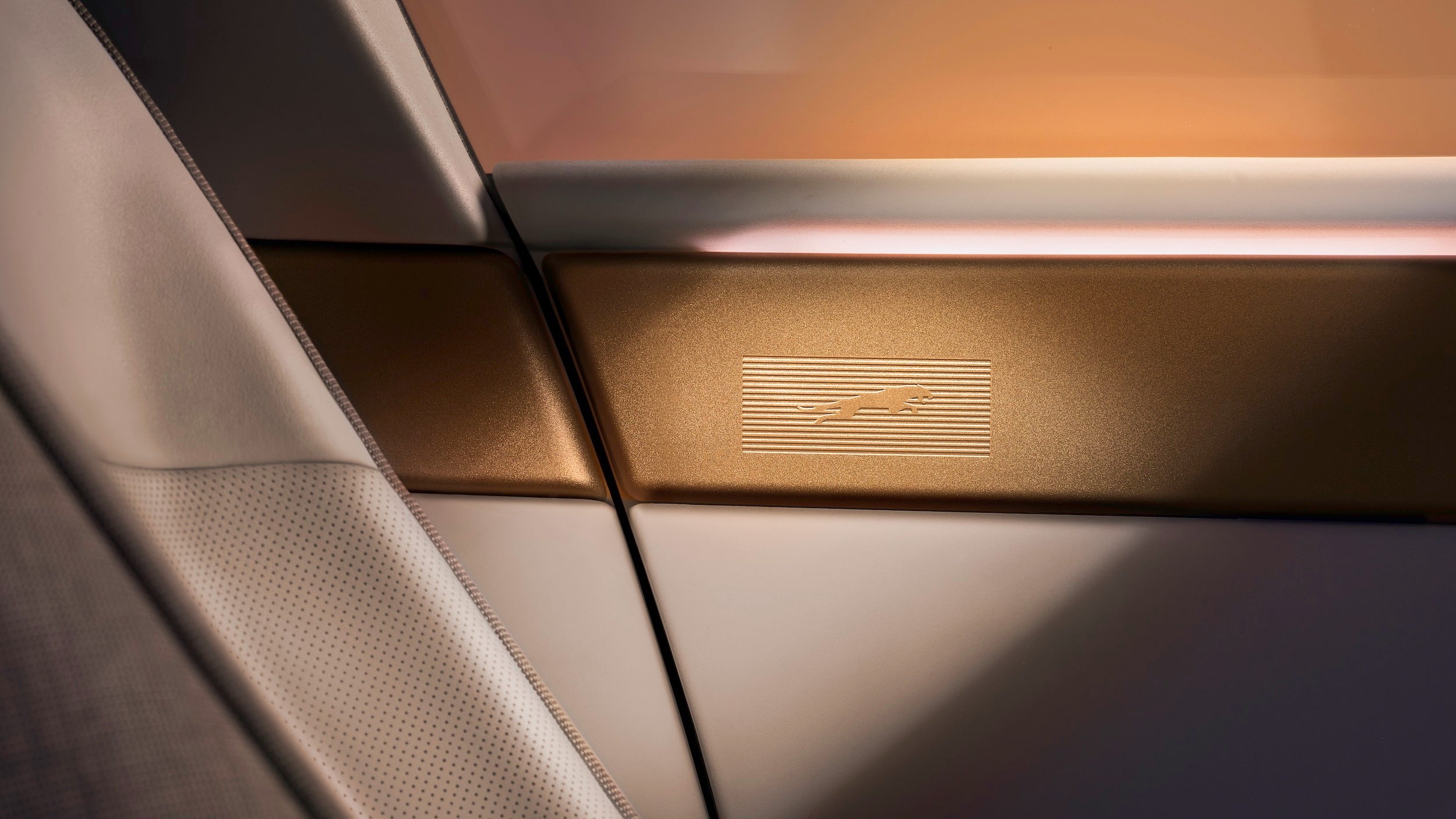 The new Jaguar leaper features subtly inset into brass on the top of the Type 01's doors