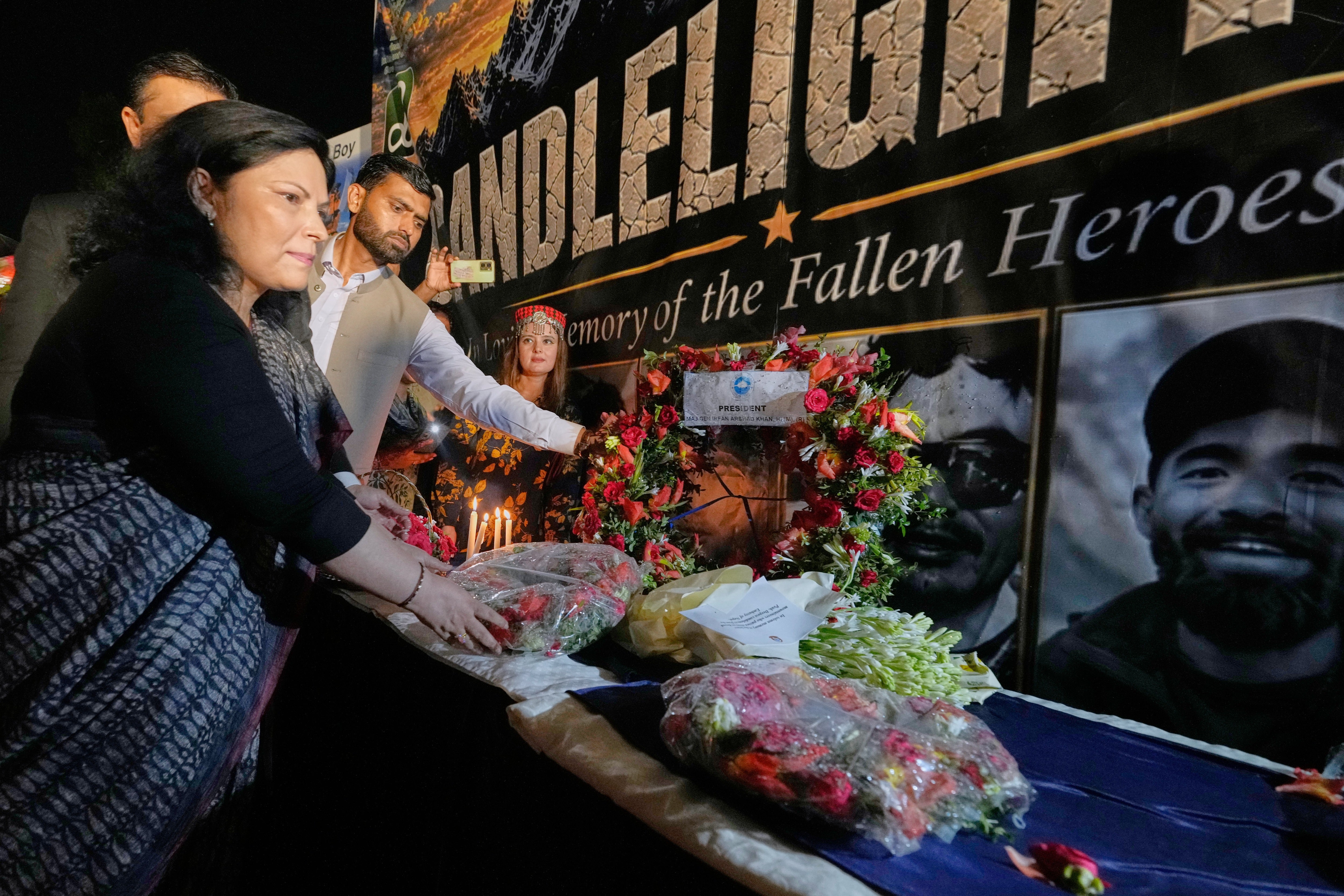 Nepalese Ambassador to Pakistan Rita Dhital, left, and others mourn the climbers who died in the avalanche