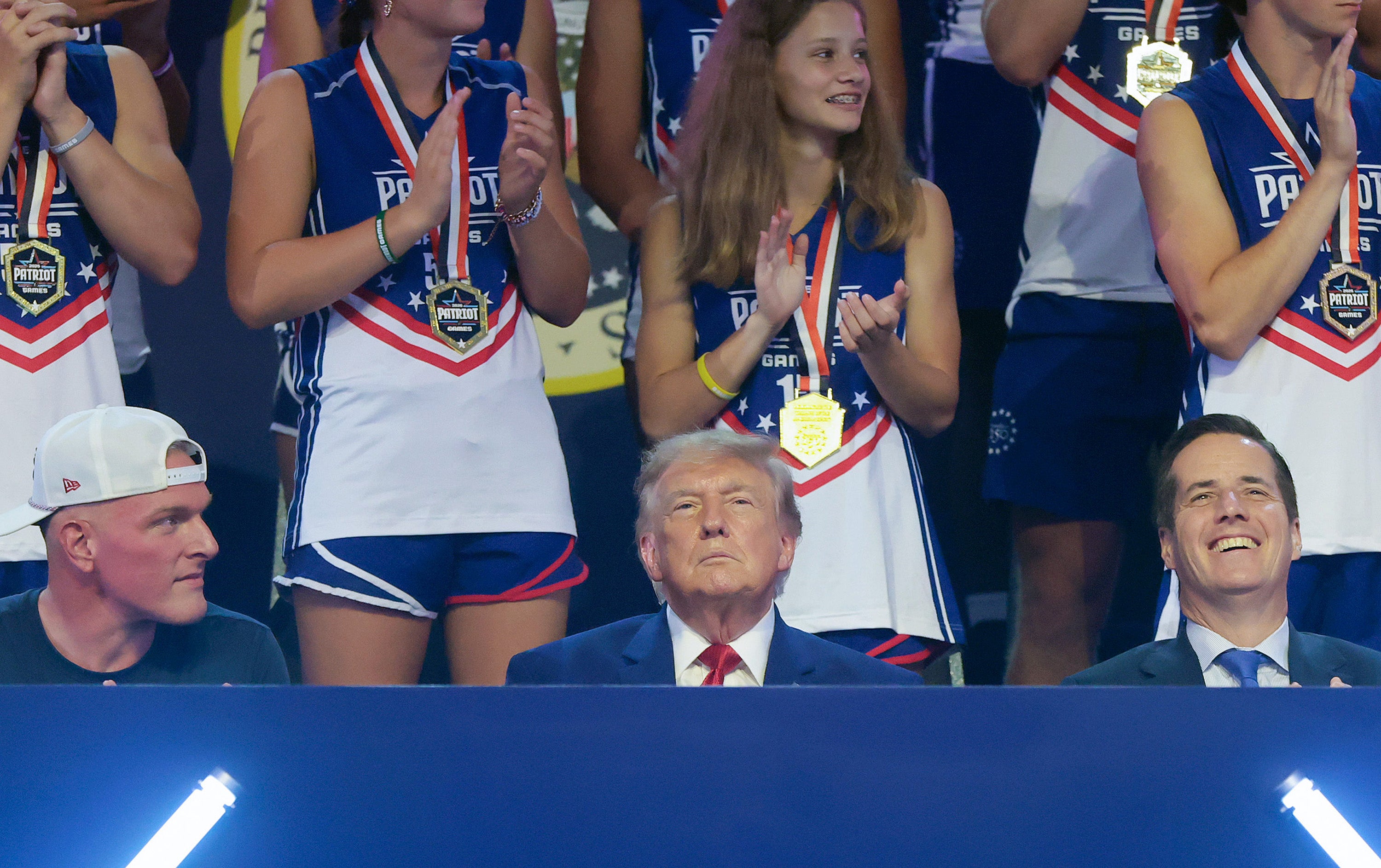 The president takes in the festivities with ESPN’s Pat McAfee (left) and Senator Bernie Moreno (R-OH) (right)