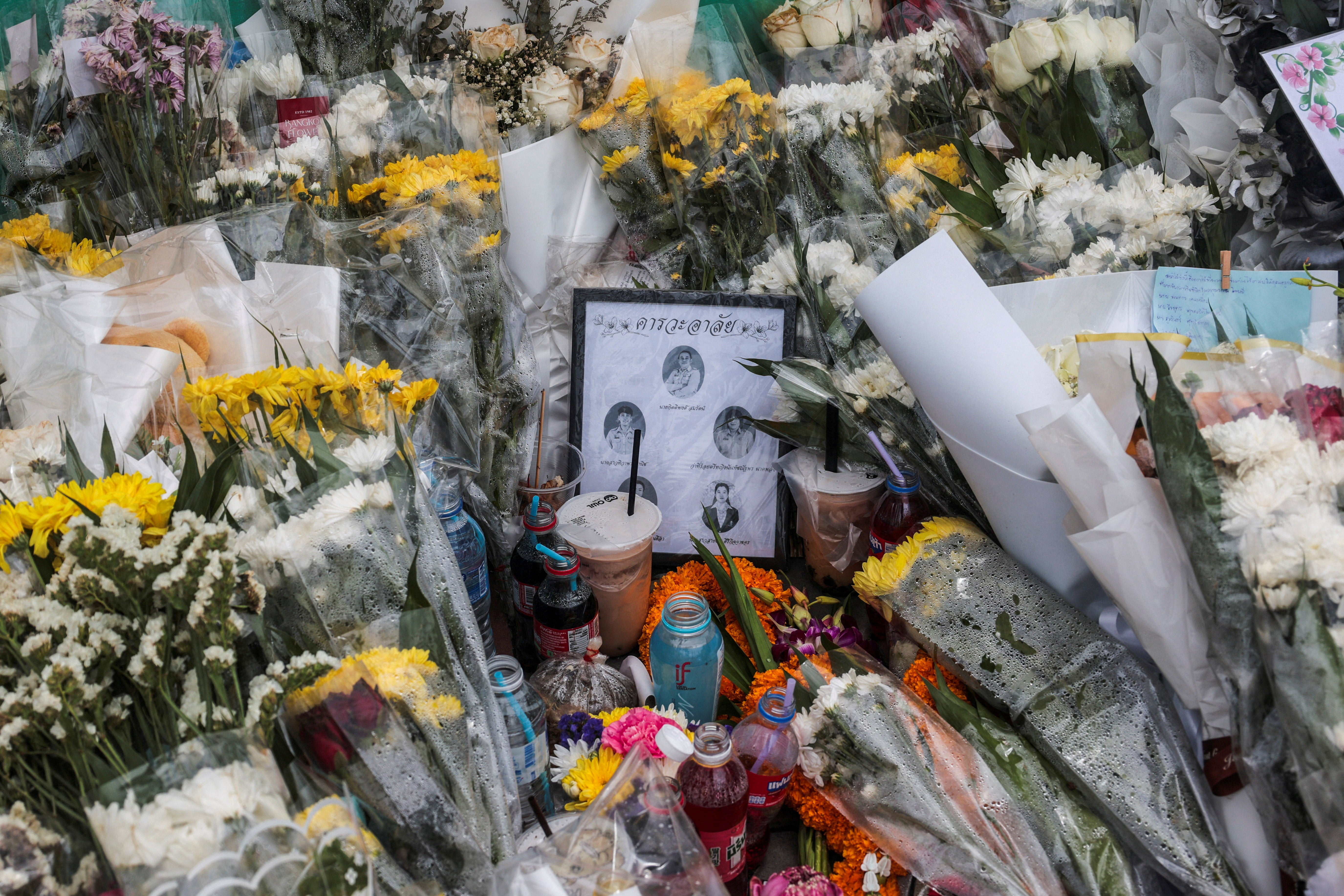 File. Flowers and pictures of teachers and school officials killed are left outside Debsirin Nonthaburi School following a deadly shooting at the school, in Bang Kruai district in Nonthaburi province, on the outskirts of Bangkok, Thailand