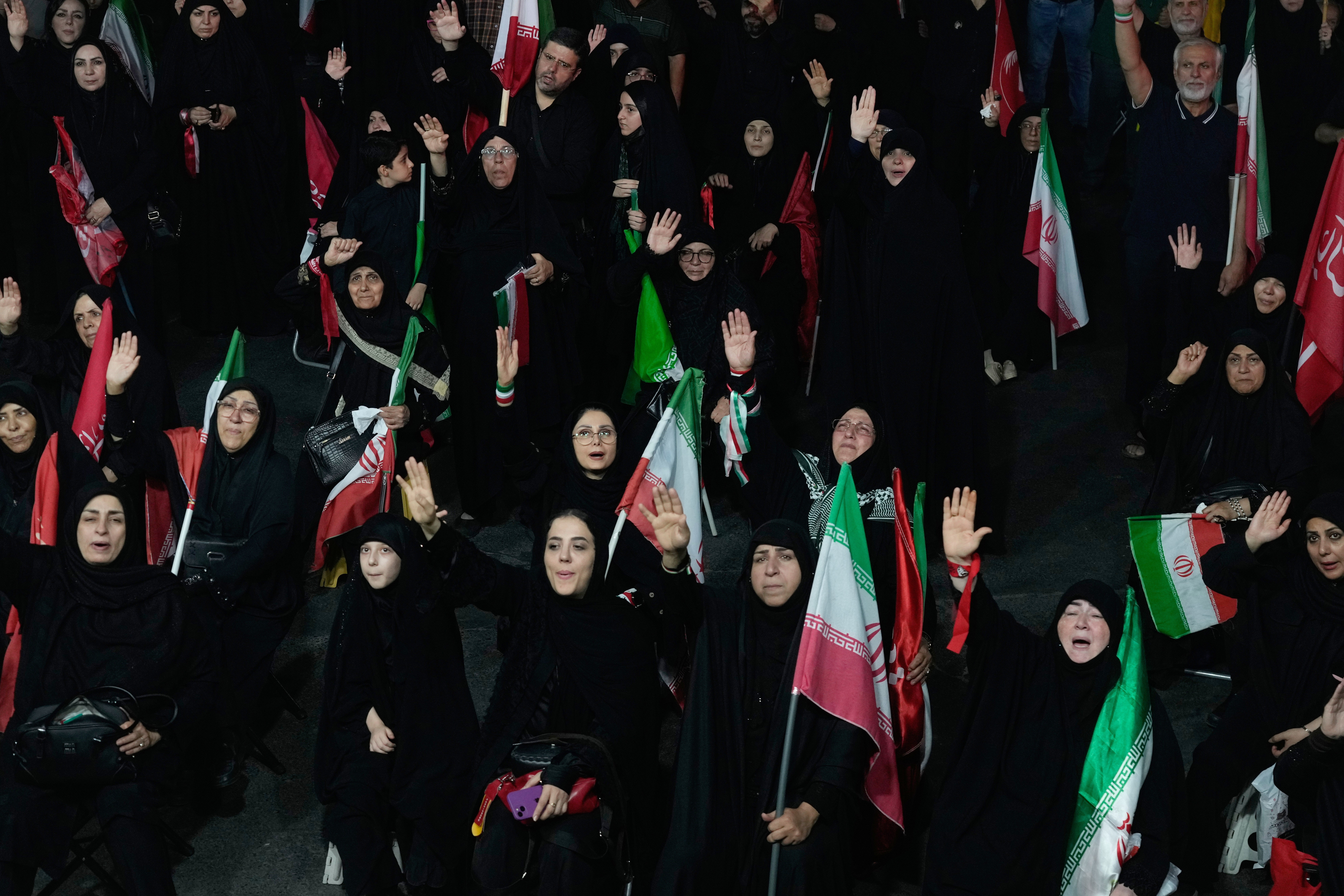 Iranian pro-government demonstrators attend a gathering at a square in Tehran