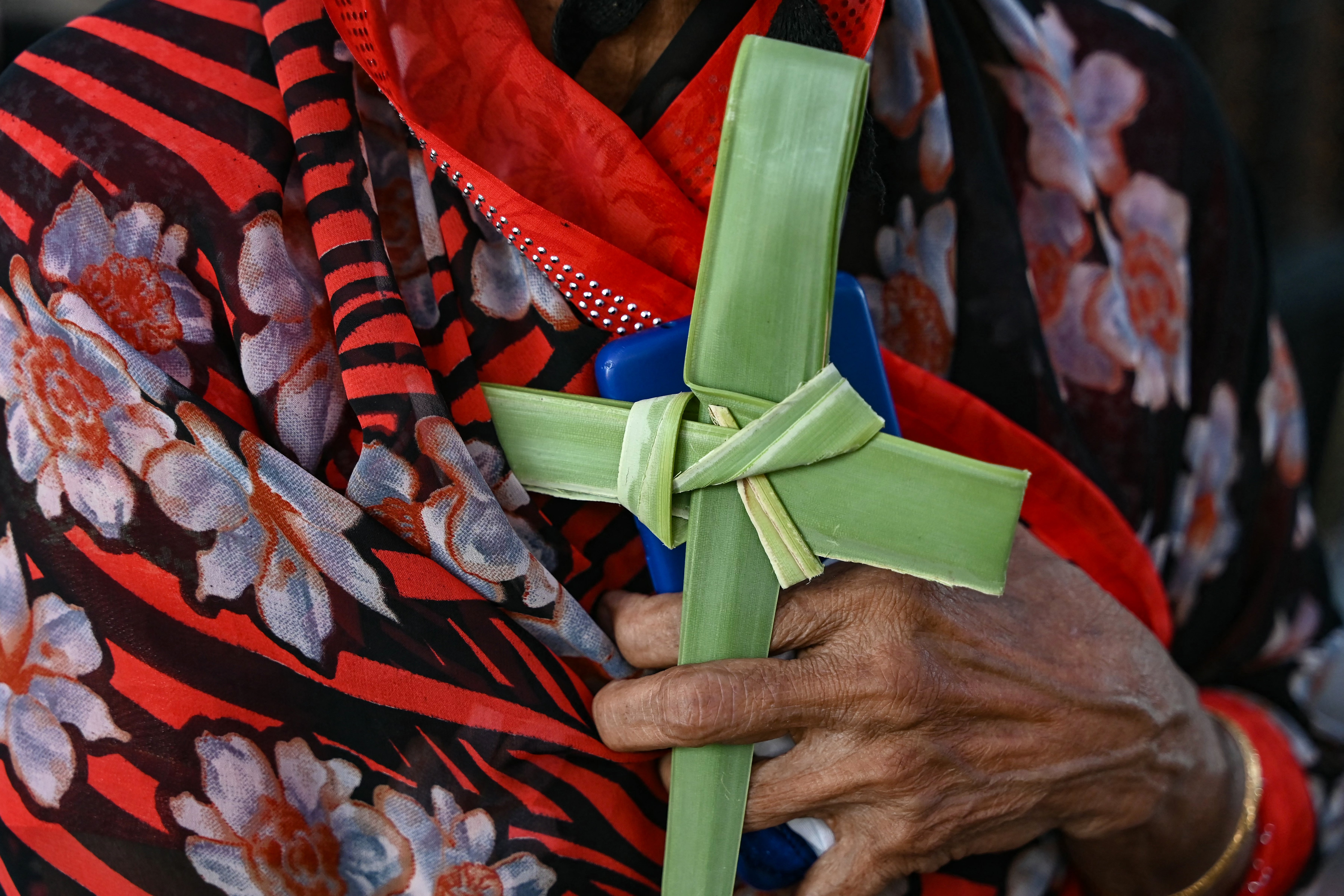 A Christian devotee holds a palm leaf shaped into a cross during a religious procession in Hyderabad, India, on 29 March 2026